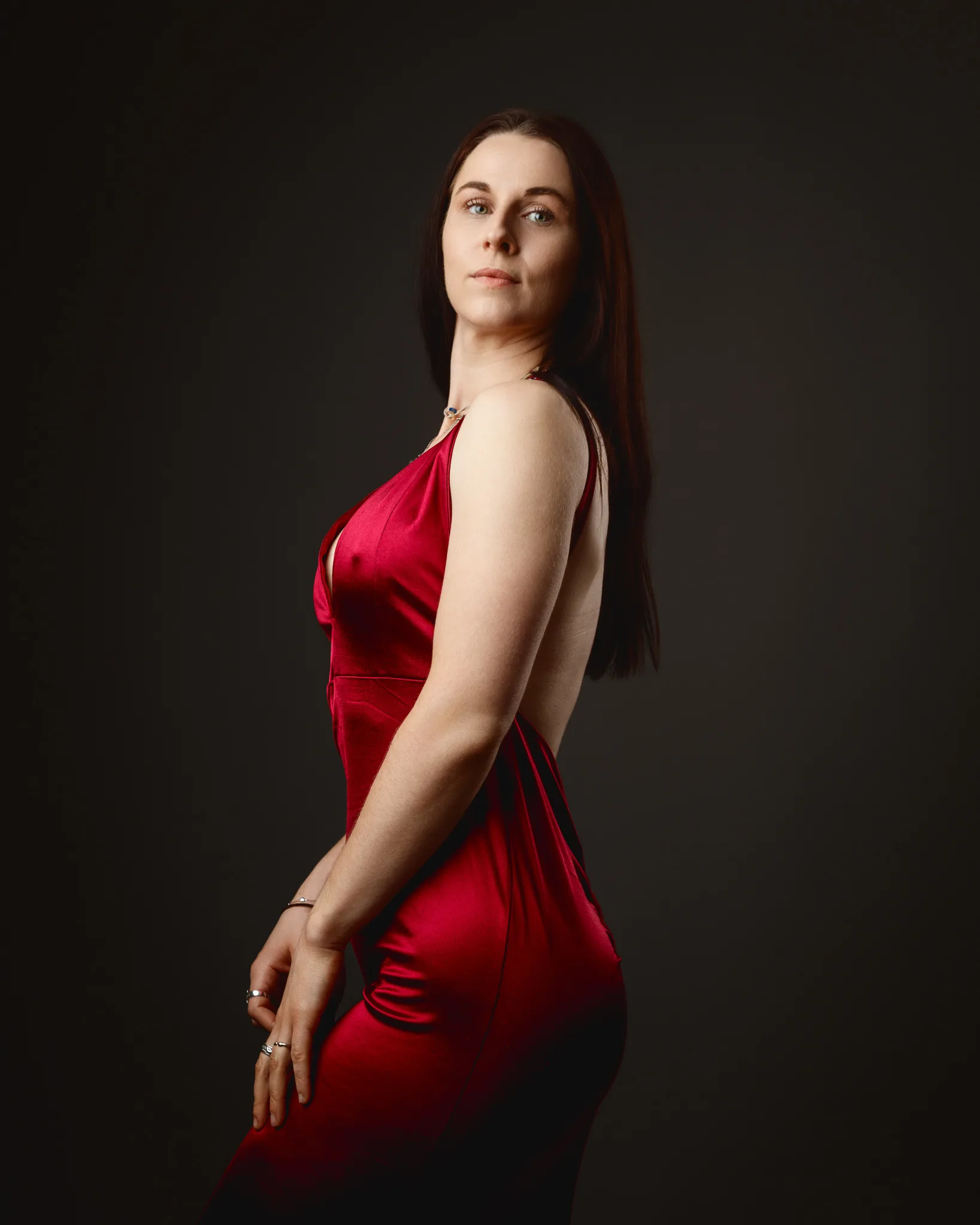 Woman in red evening dress posing in studio