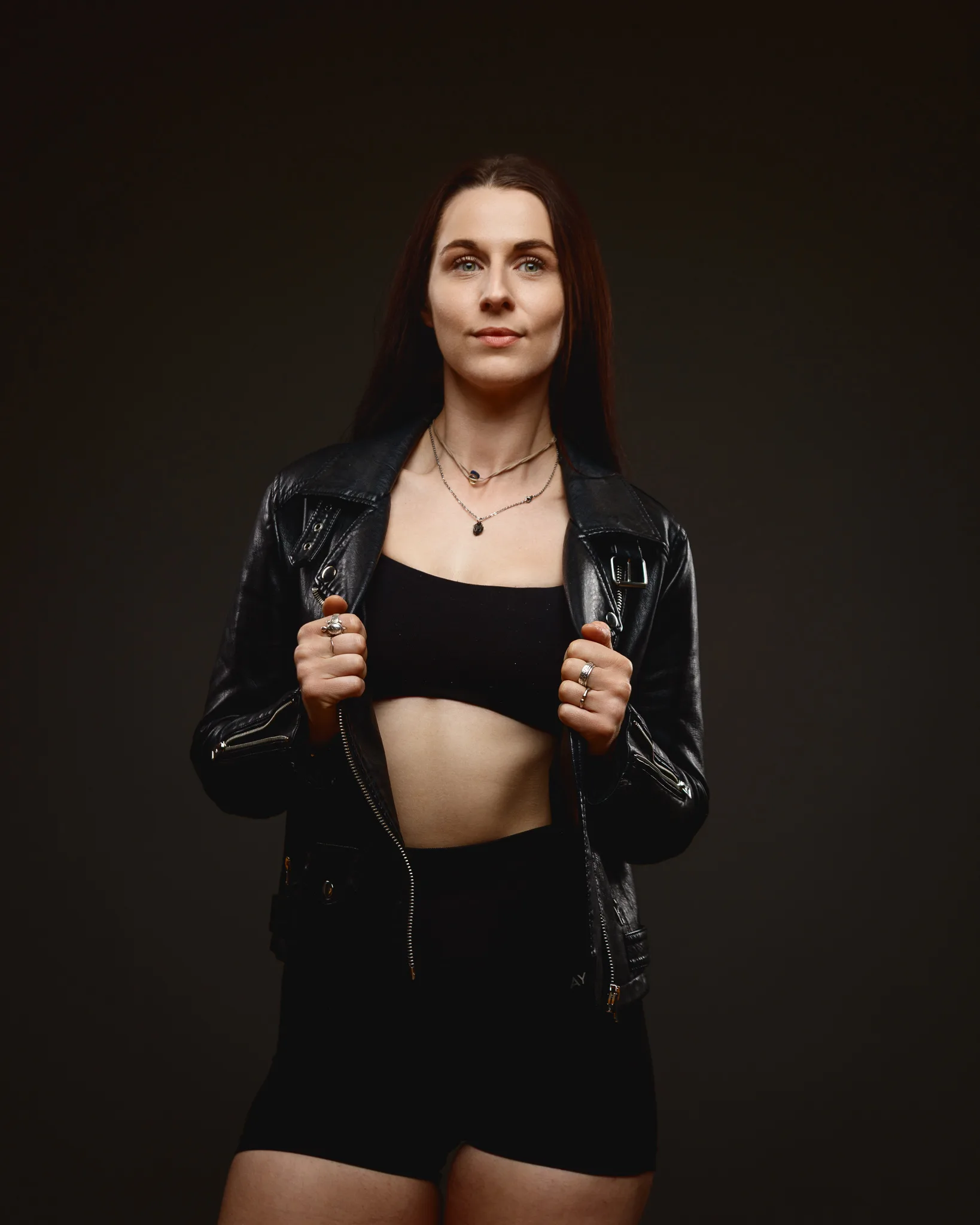 Woman in black leather jacket and crop top portrait