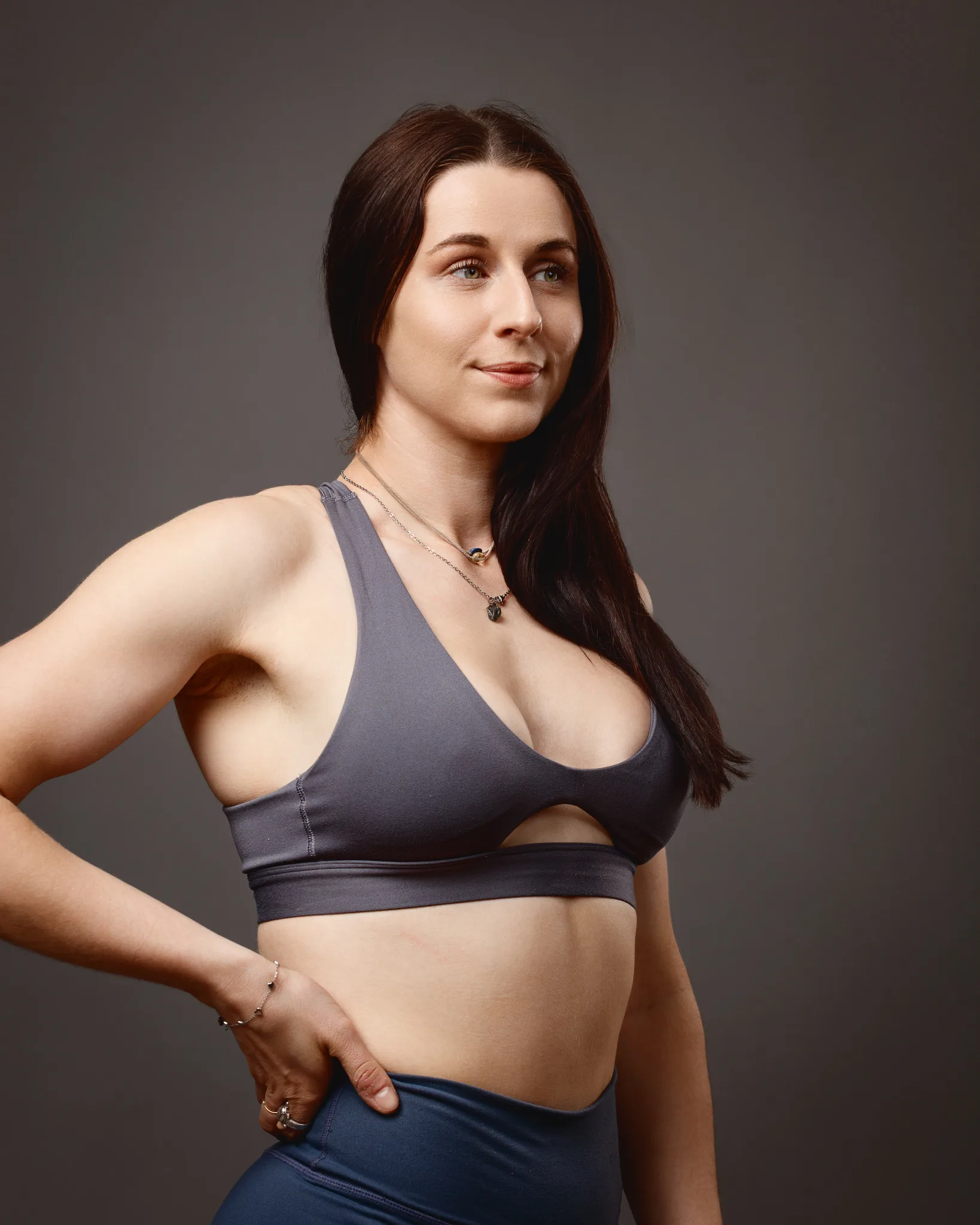 Woman in grey sports bra studio portrait