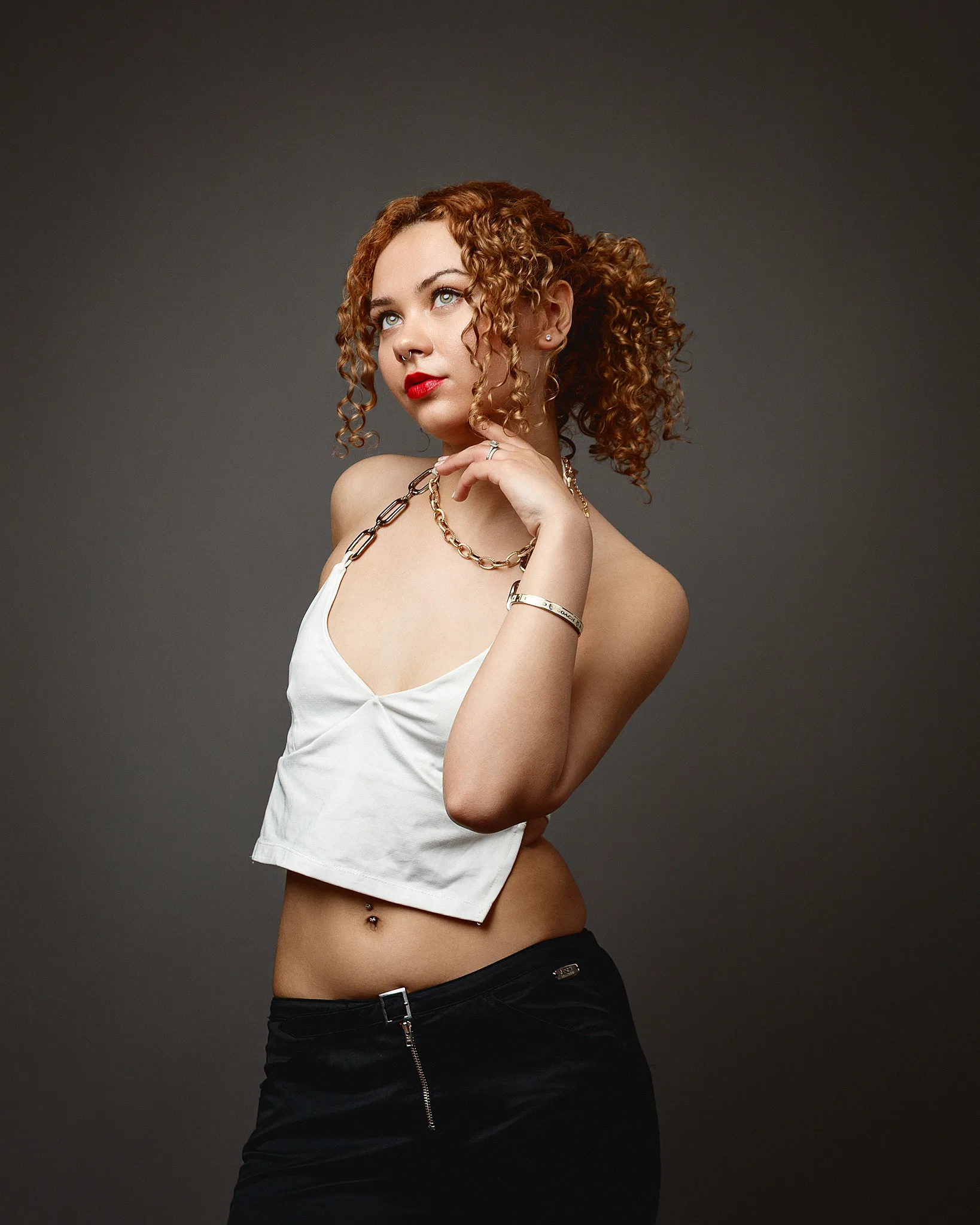 Woman with curly hair posing in studio portrait