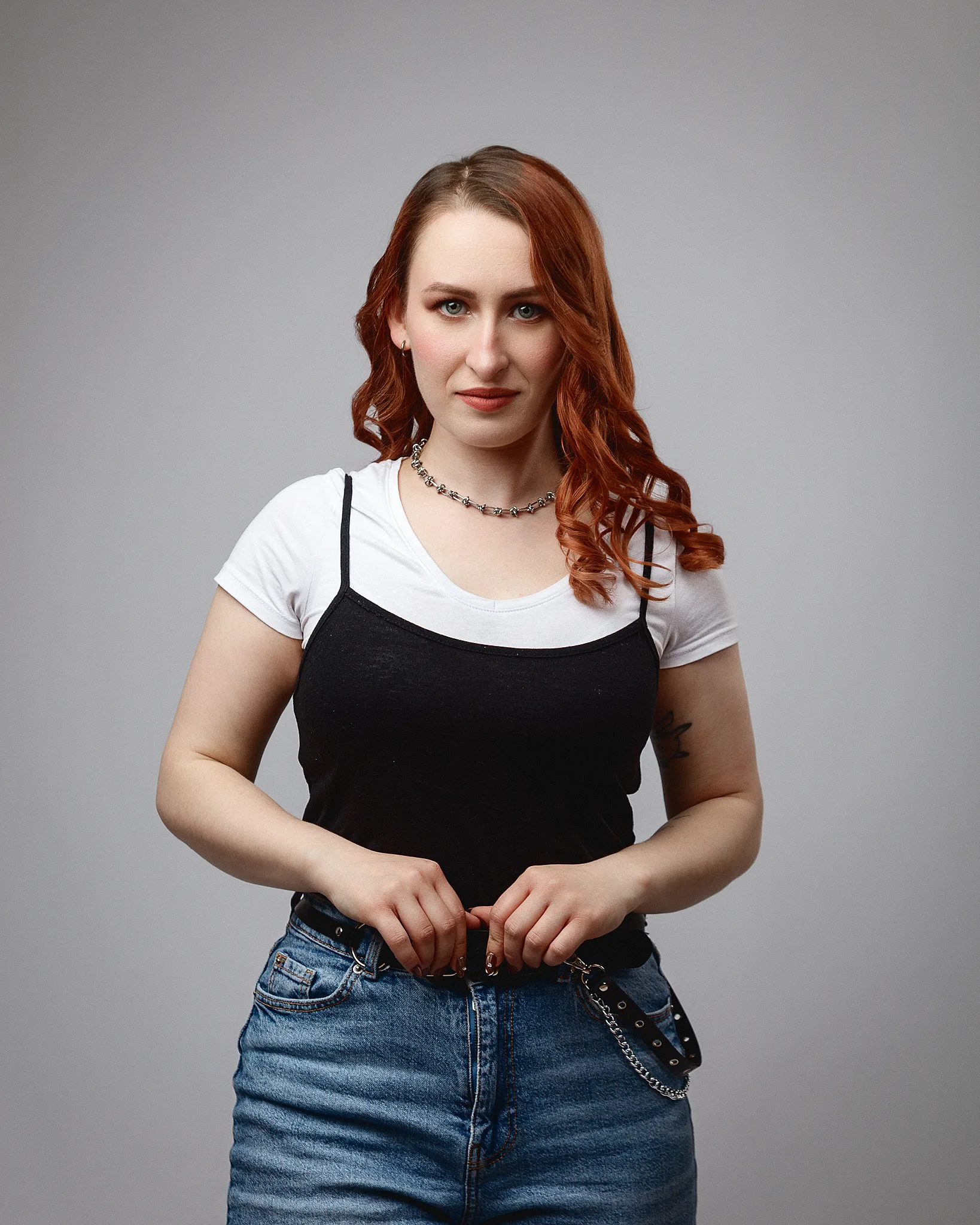 Red-haired woman in casual outfit against grey background