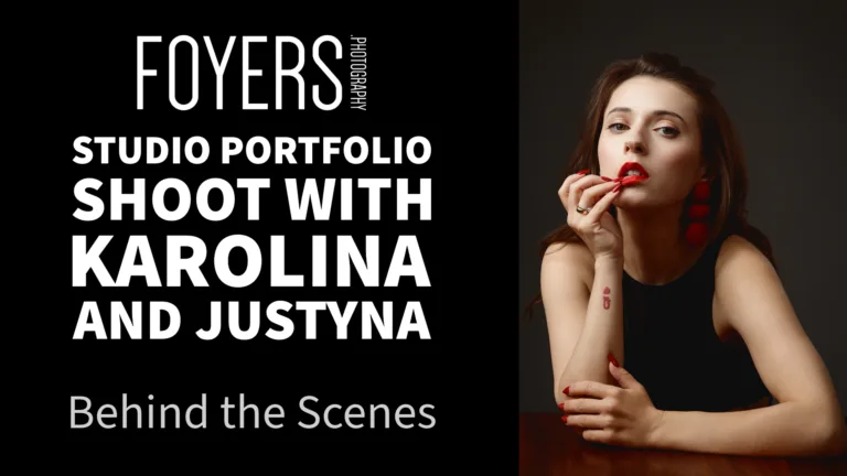 Studio portrait of woman applying red lipstick