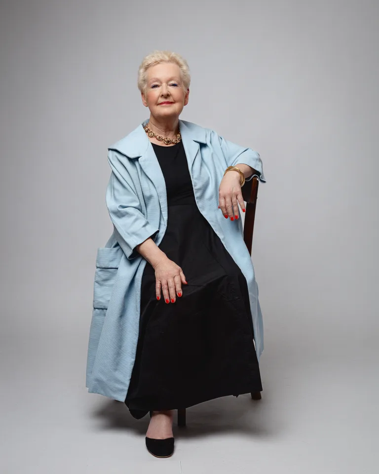 Elegant older woman seated in studio portrait