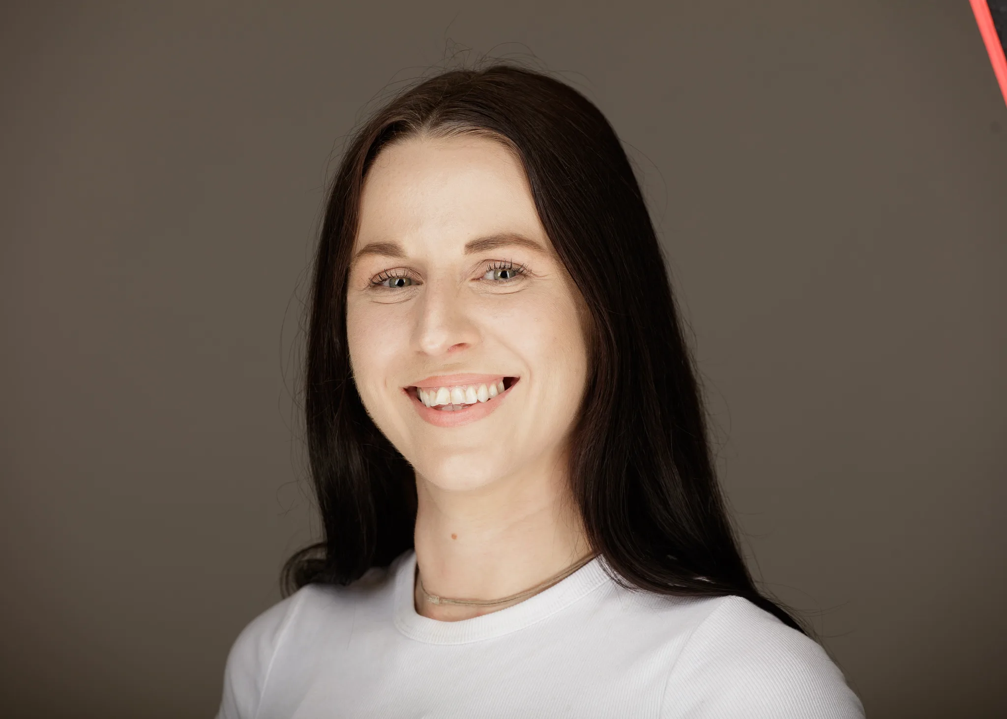 Smiling woman with long dark hair portrait