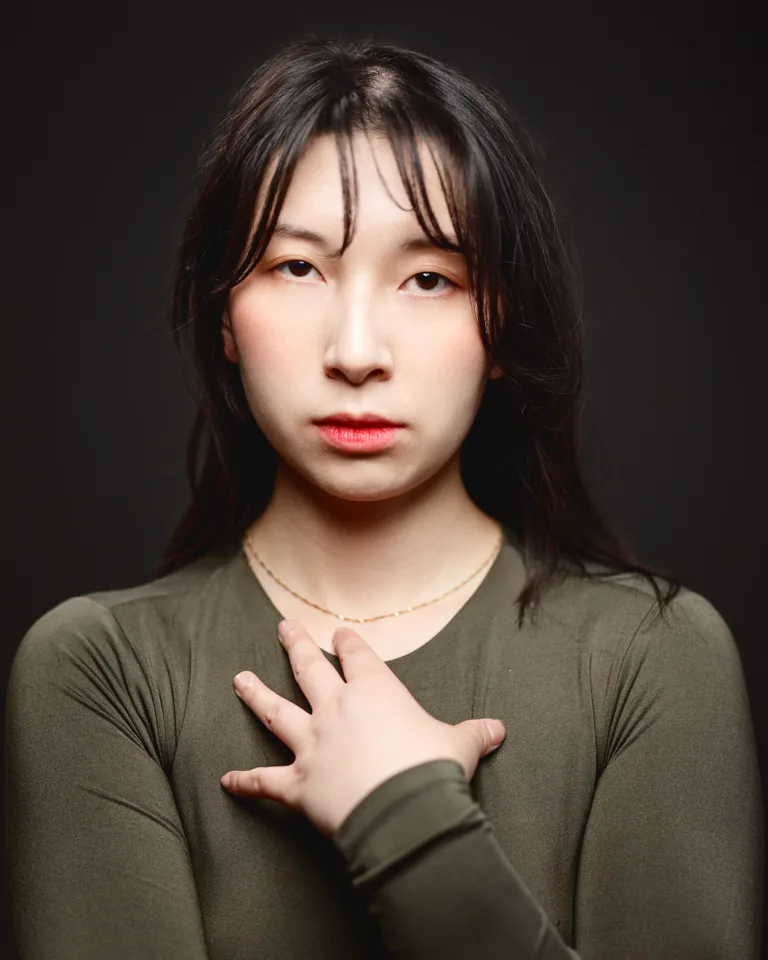 Portrait of woman with hand on chest