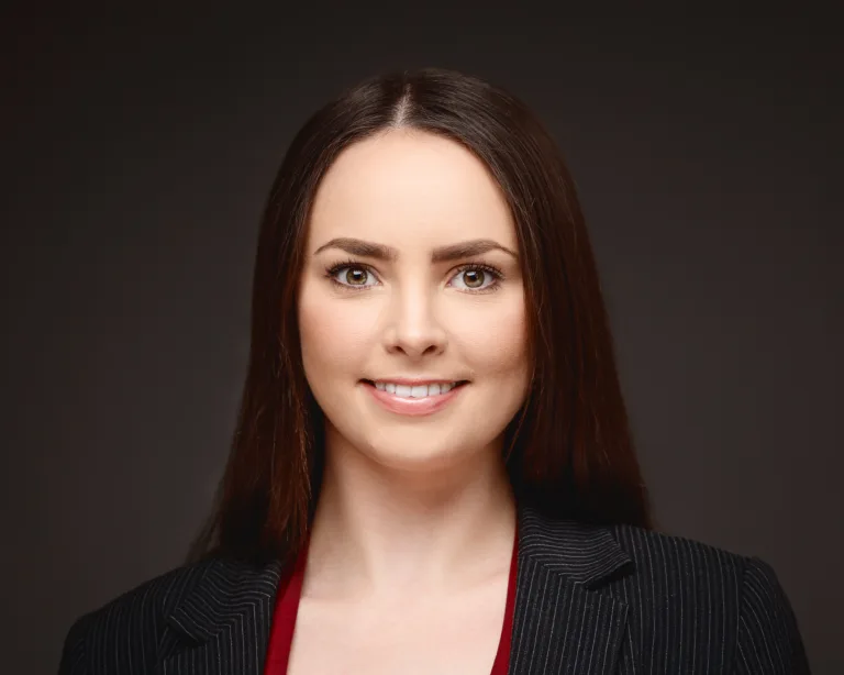 Professional headshot of smiling woman in blazer