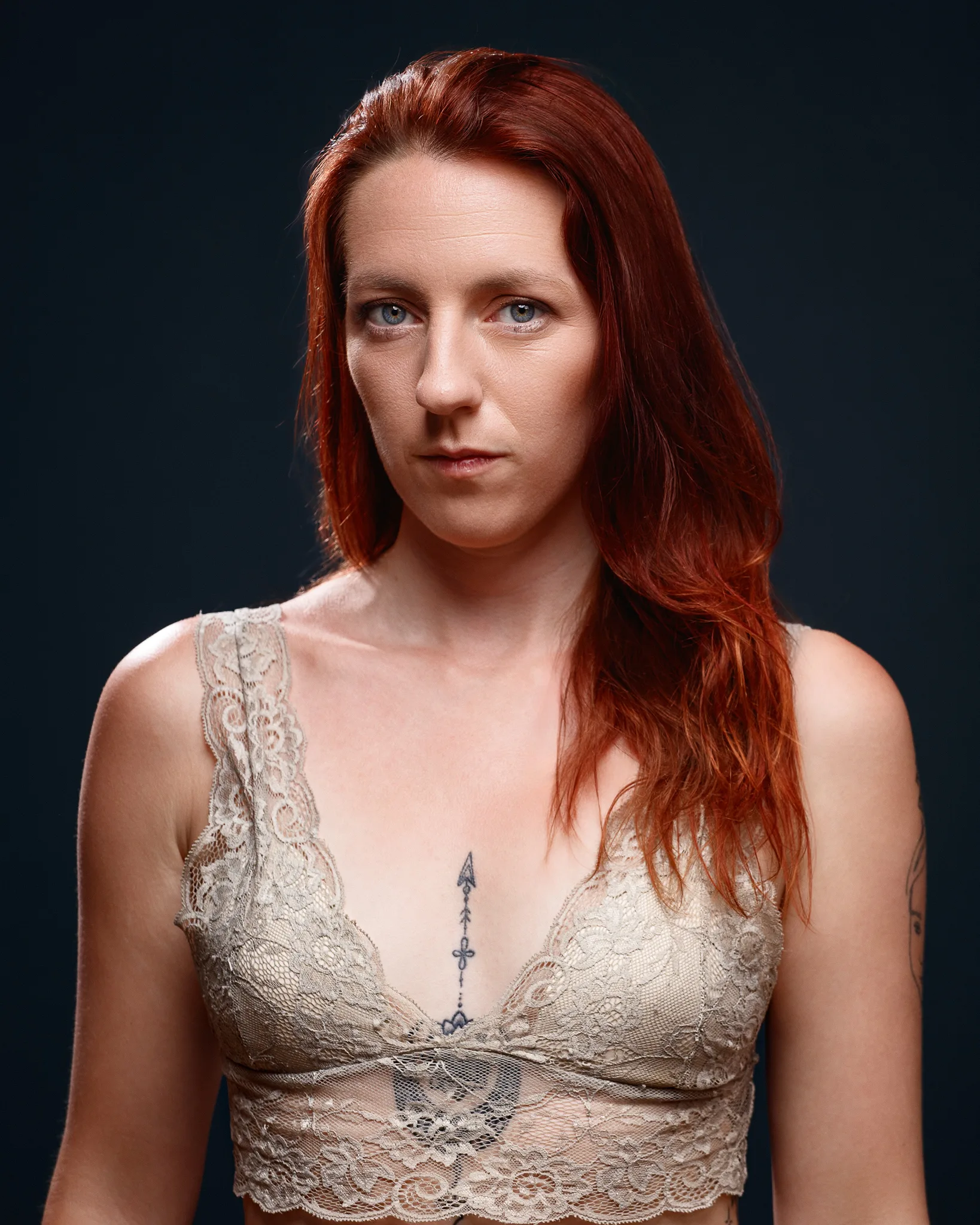 Portrait of red-haired woman against dark background
