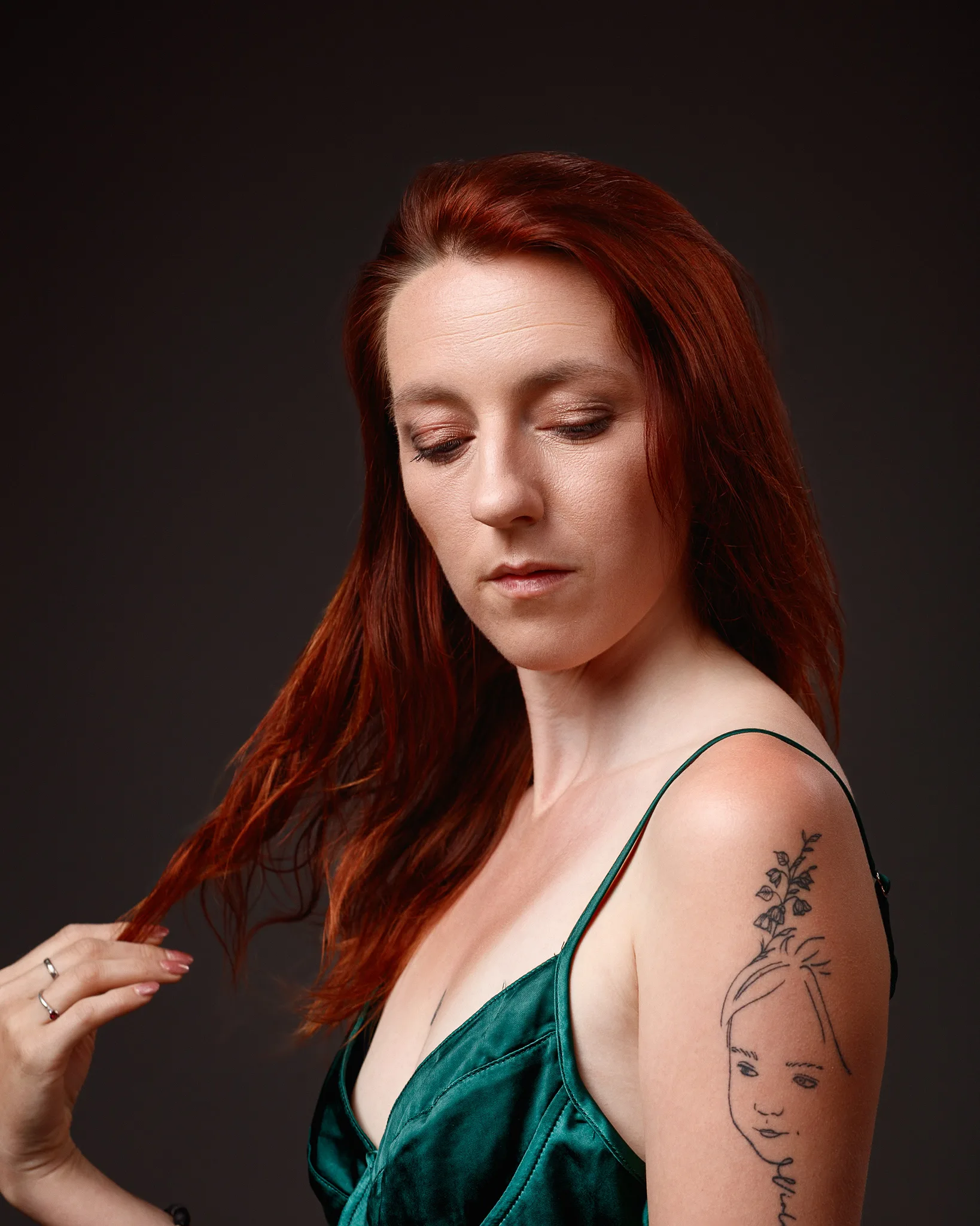 Red-haired woman with floral face tattoo portrait