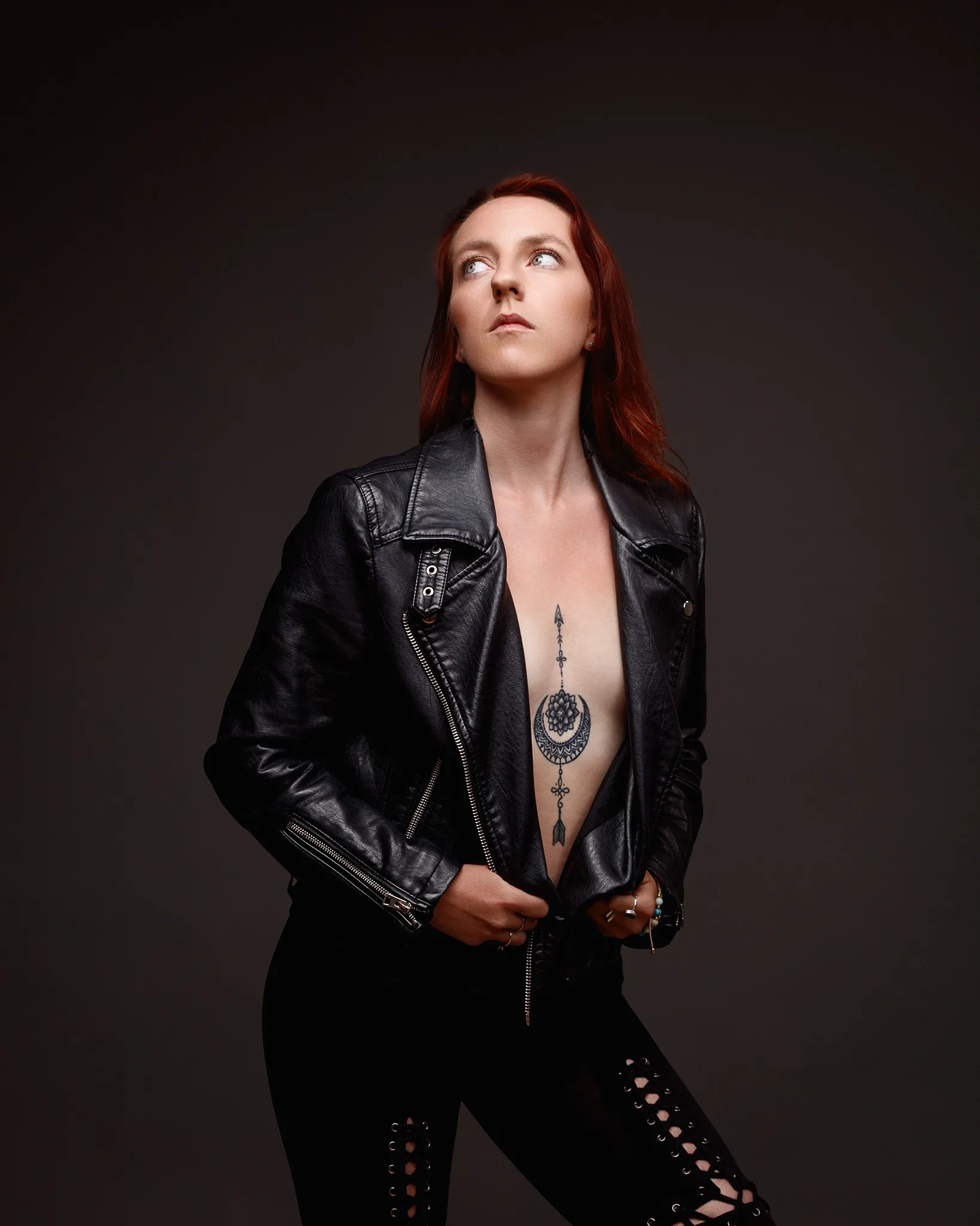 Woman in leather jacket with chest tattoo