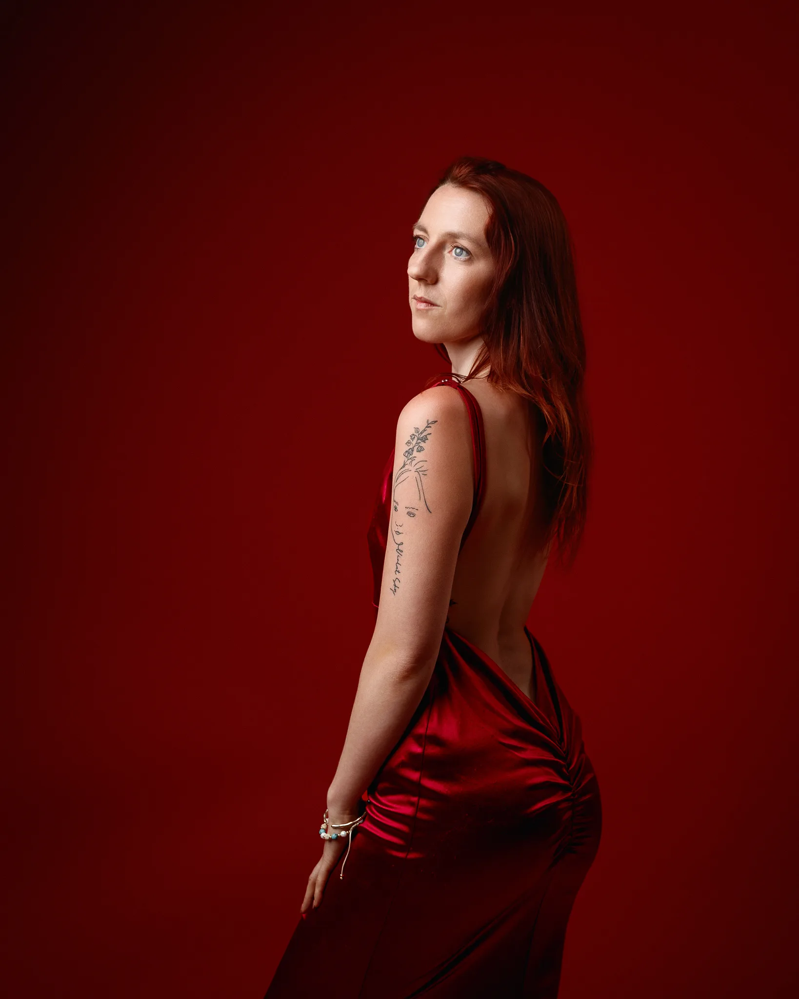 Woman in red dress against red background