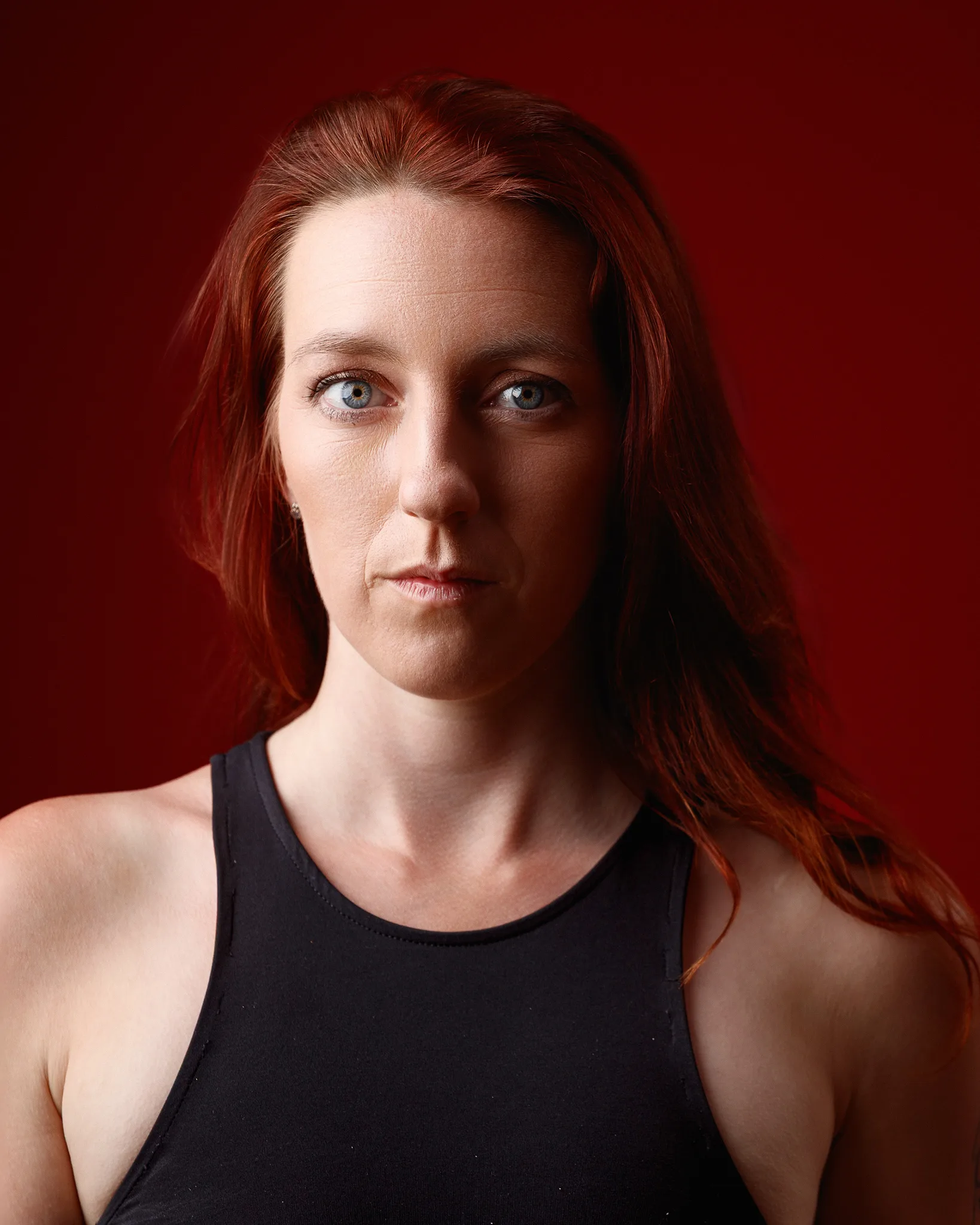 Red-haired woman against bold red background