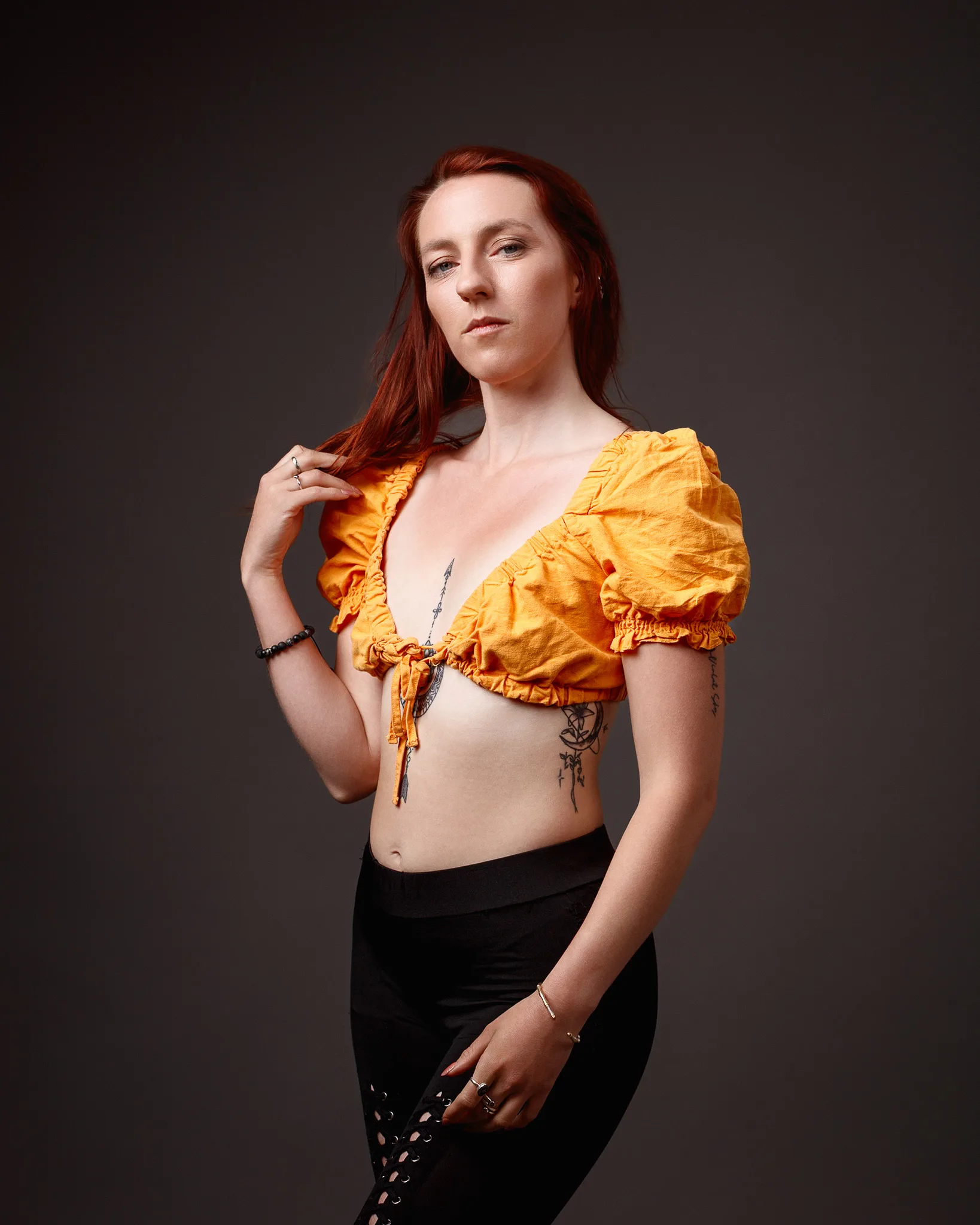 Woman with red hair in yellow crop top