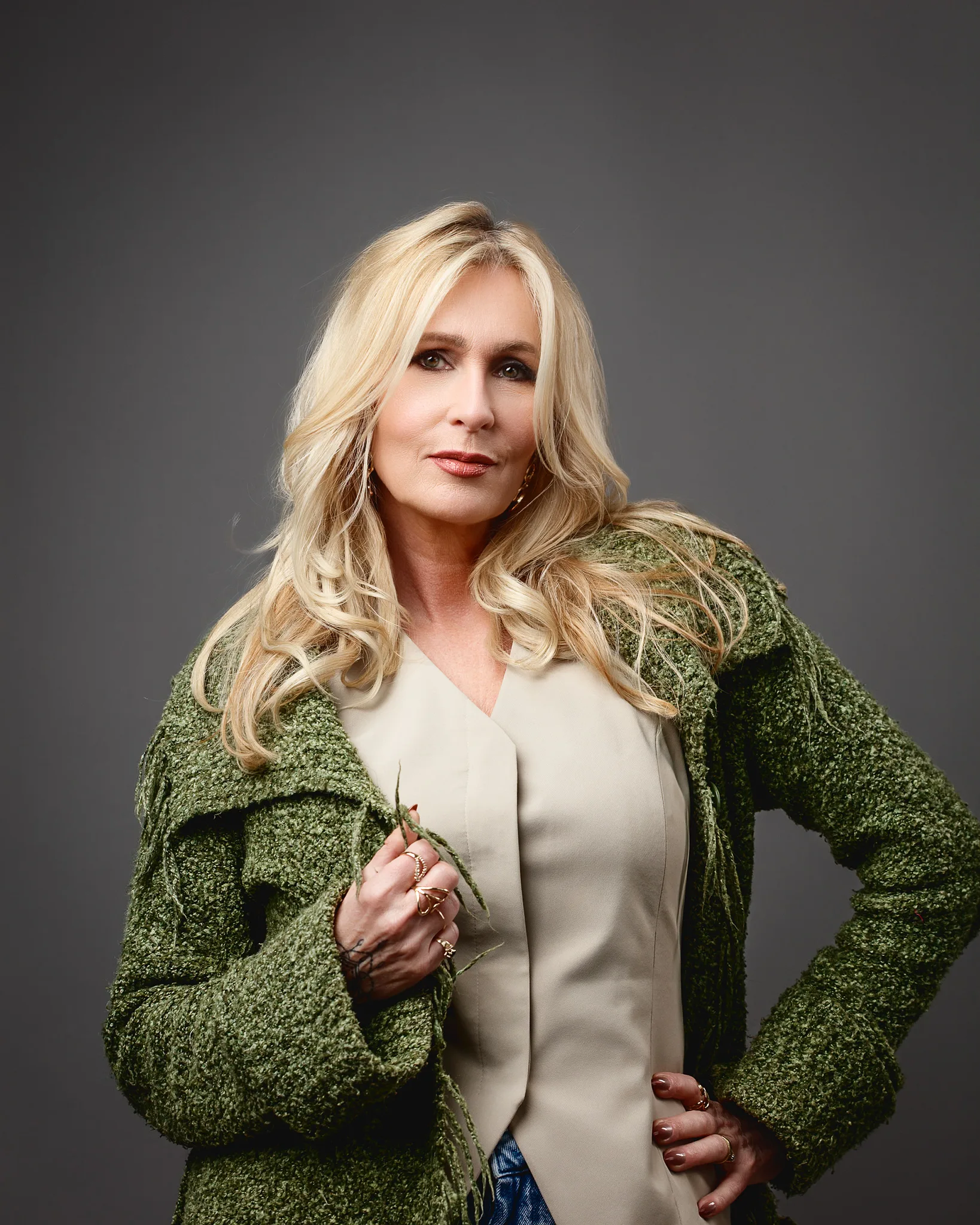 Blonde woman in green jacket portrait