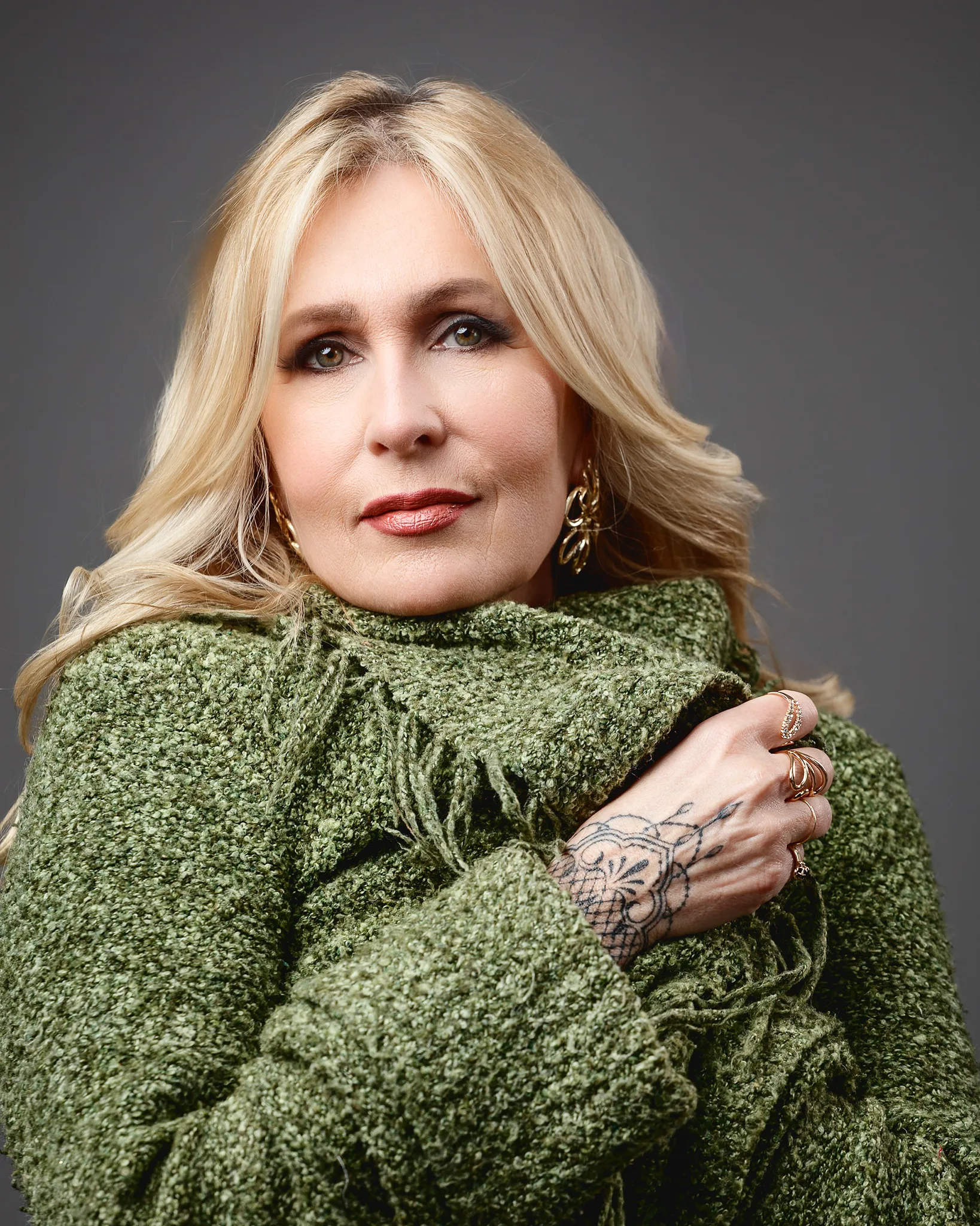 Blonde woman in green textured sweater portrait