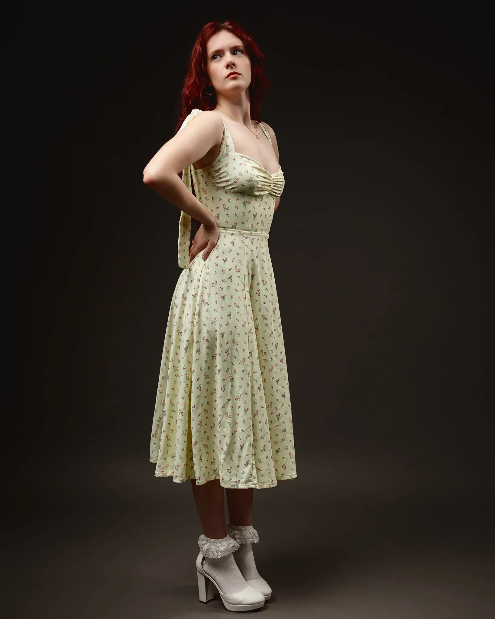 Woman in floral dress and white heels