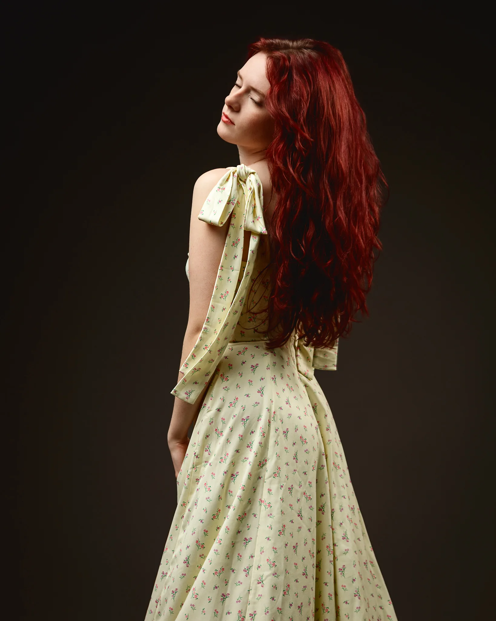 Woman with long red hair in floral dress
