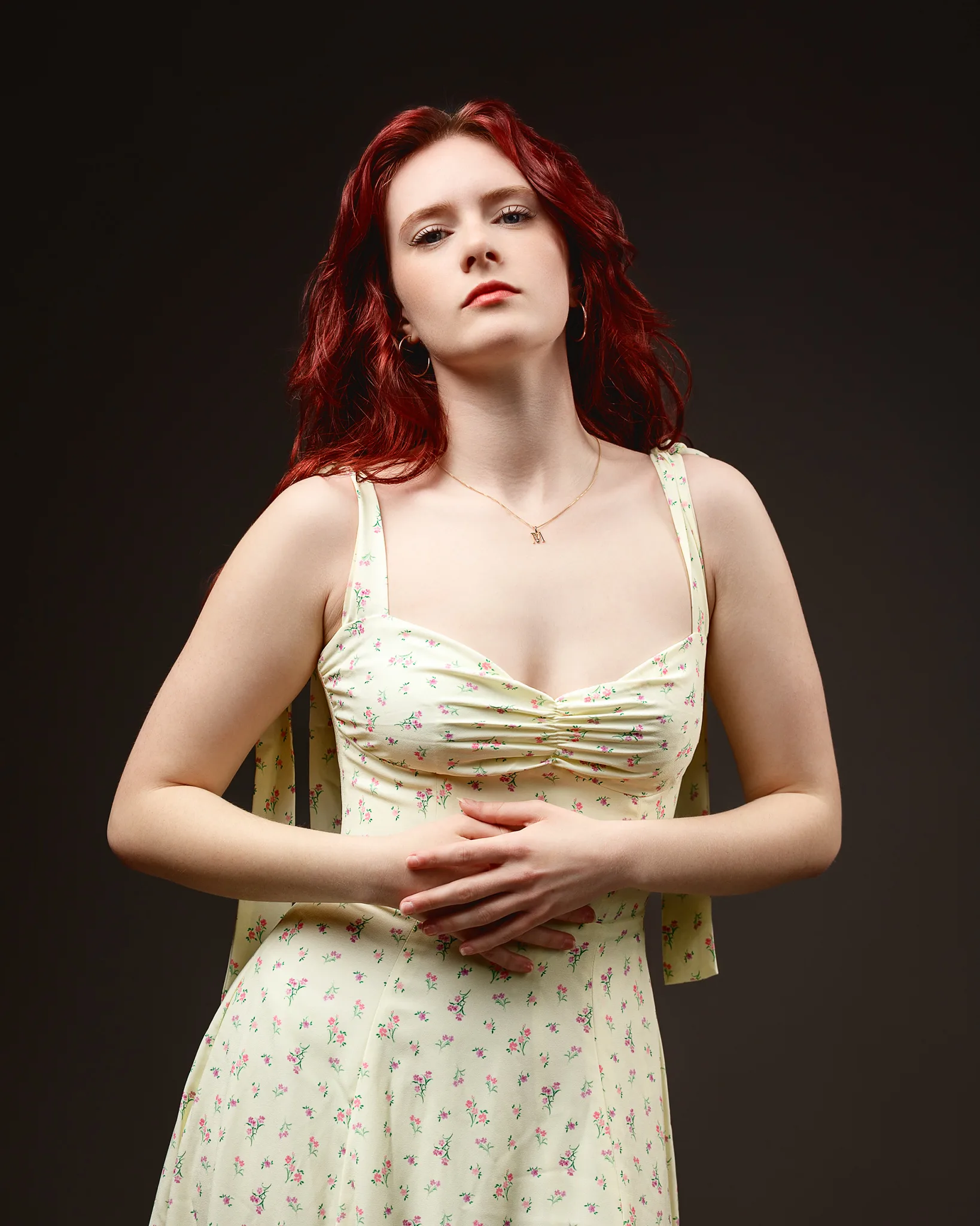 Red-haired woman in yellow floral dress portrait