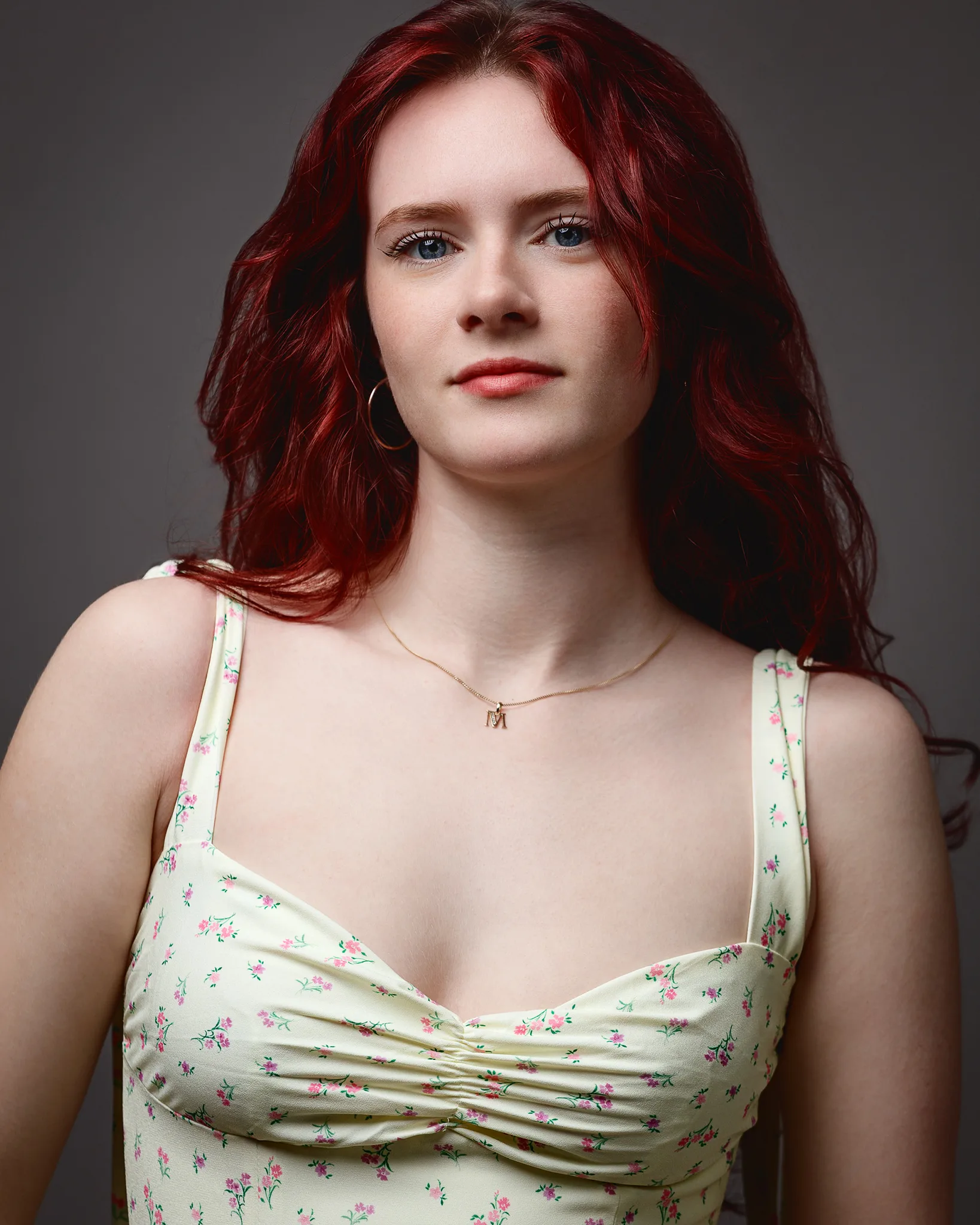 Red-haired woman in floral dress portrait