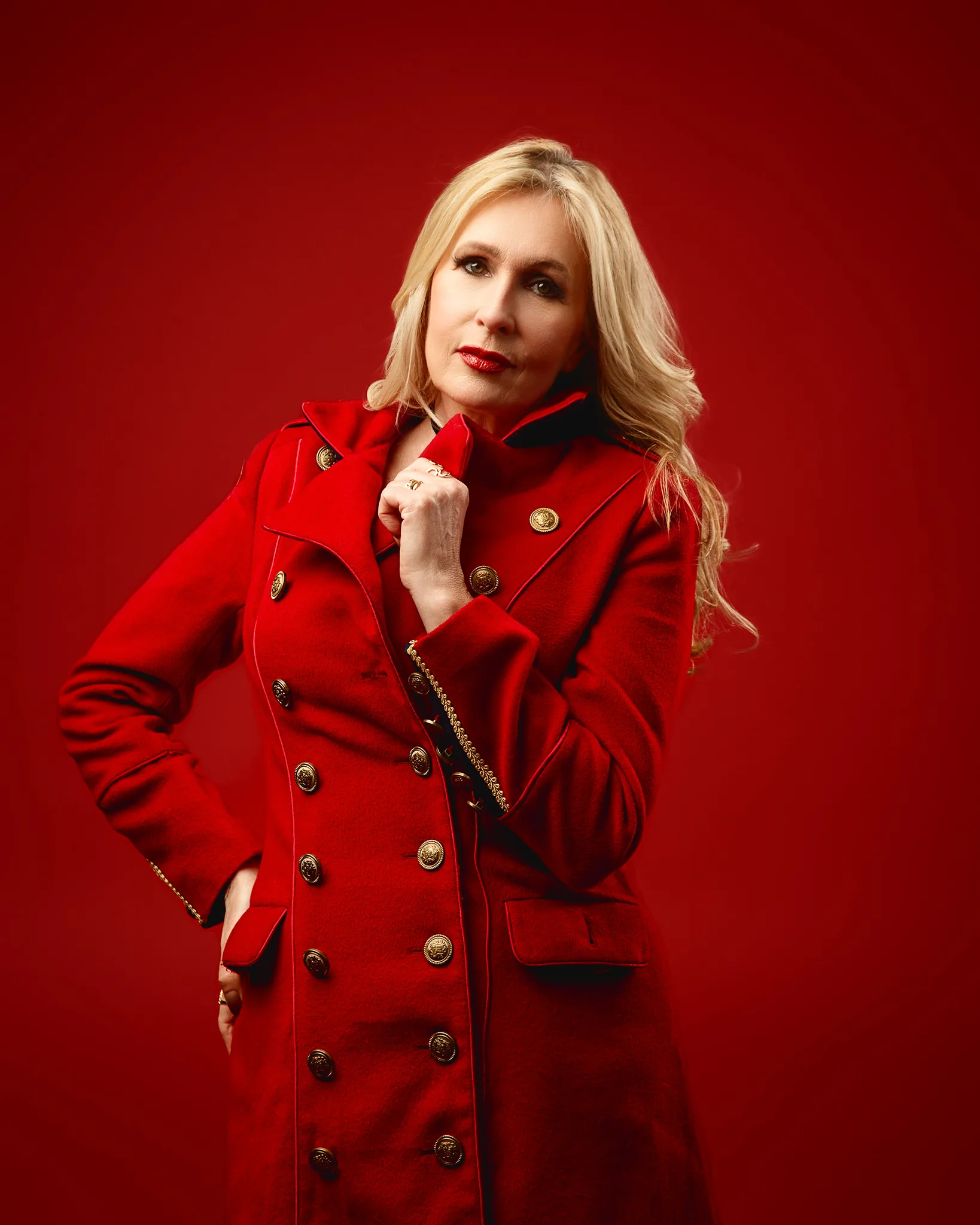 Woman in red coat against red background