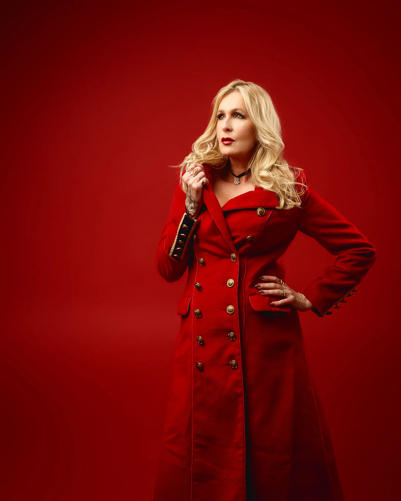 Woman in red coat against red background