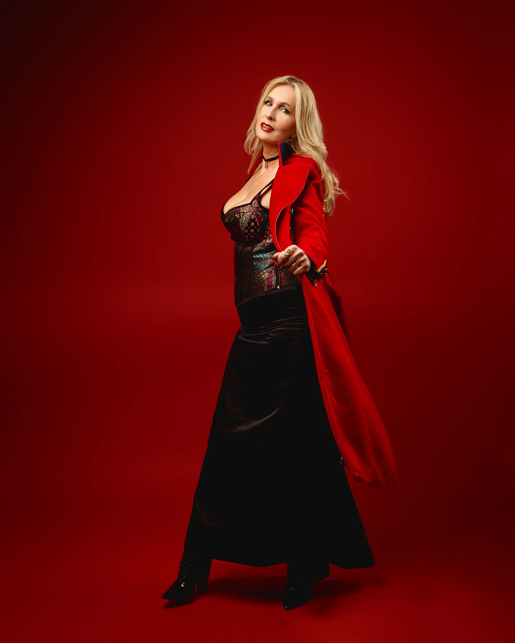 Woman in red coat against red backdrop
