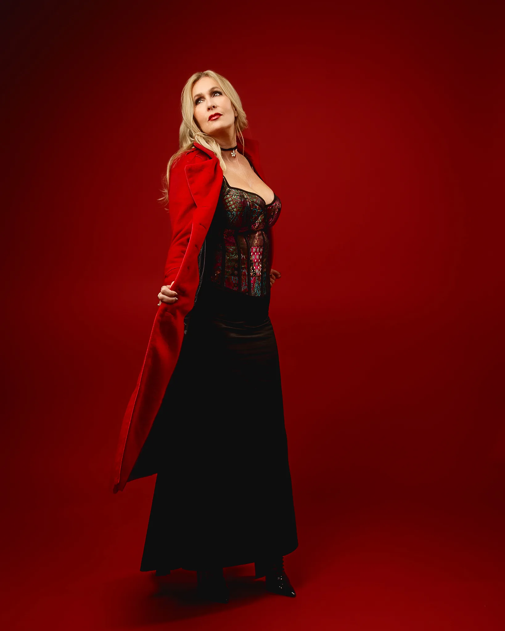 Woman in red coat against red backdrop