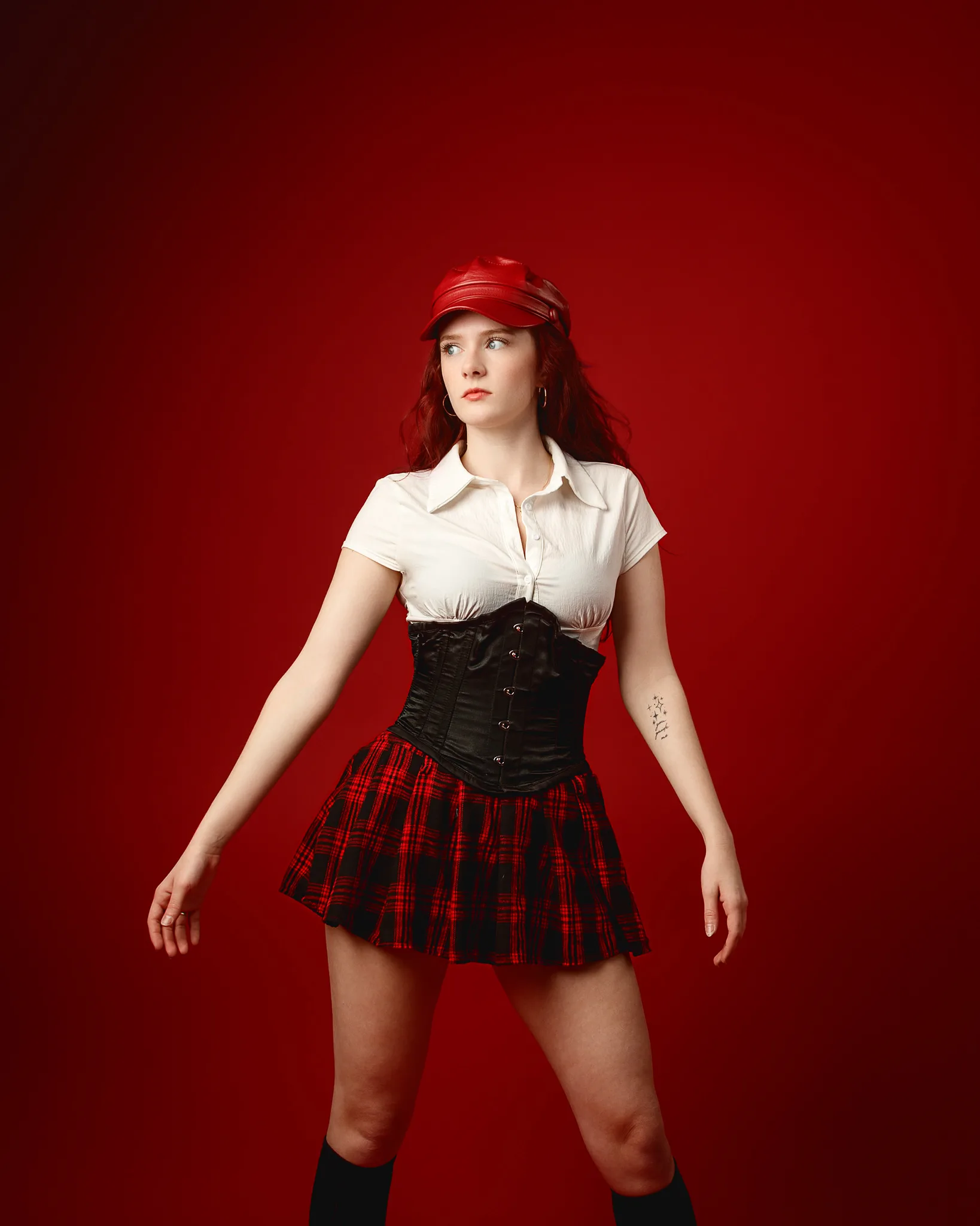Woman in red cap and tartan skirt