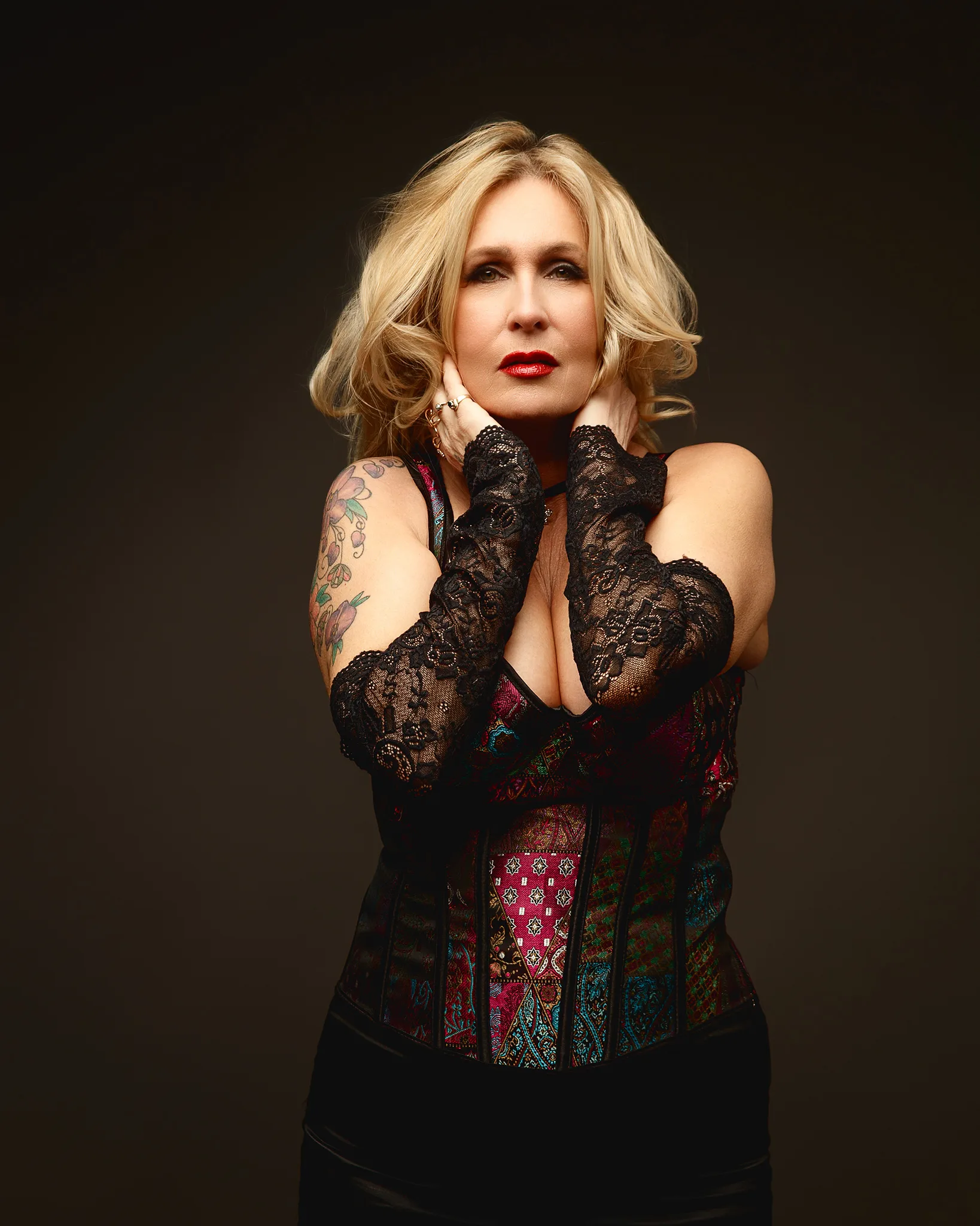 Blonde woman in corset with lace gloves
