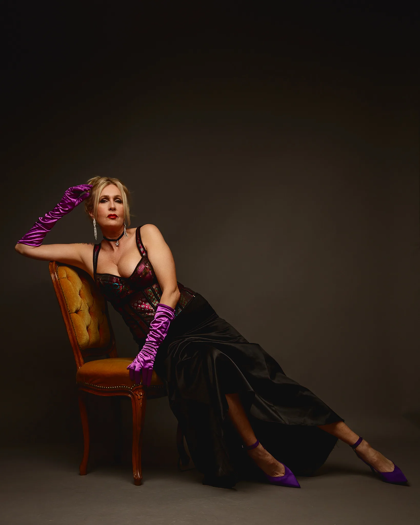 Woman posing in corset and purple gloves