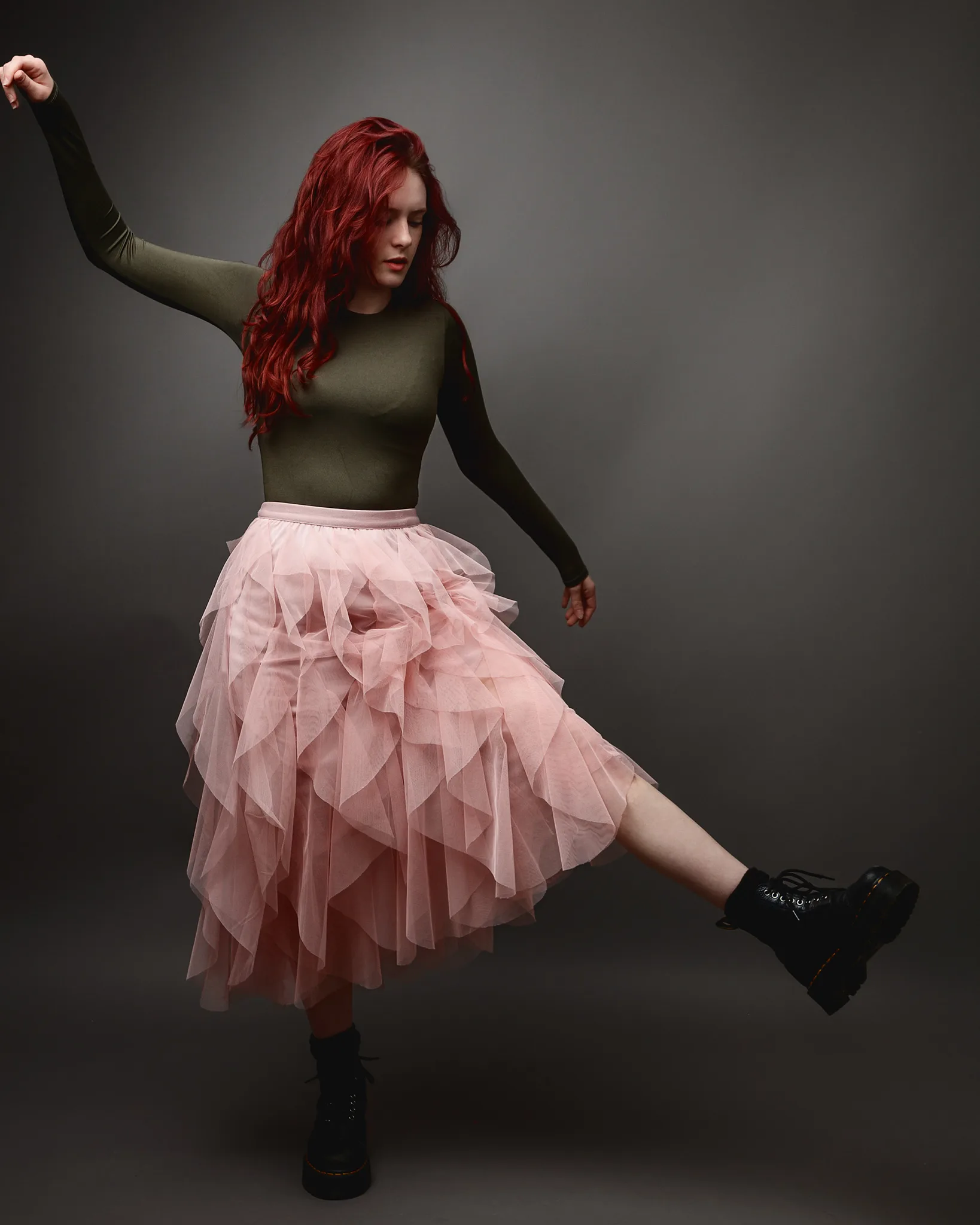 Red-haired dancer in pink tulle skirt