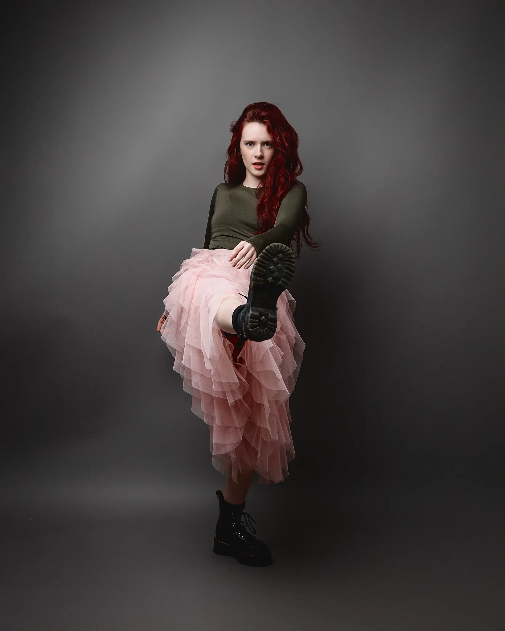 Woman in pink tulle skirt and combat boots