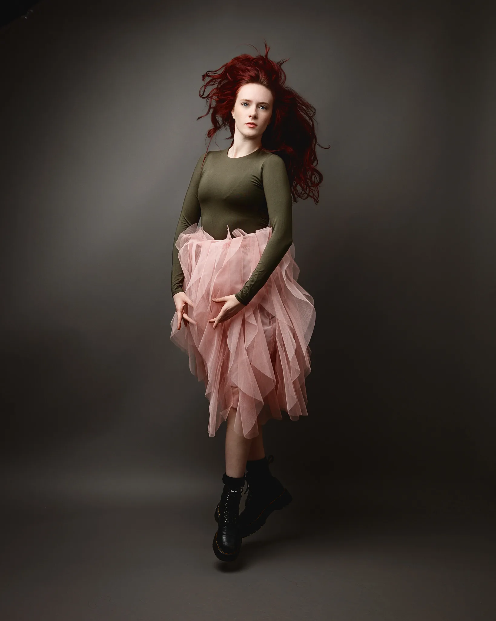 Woman with red hair in pink tulle skirt