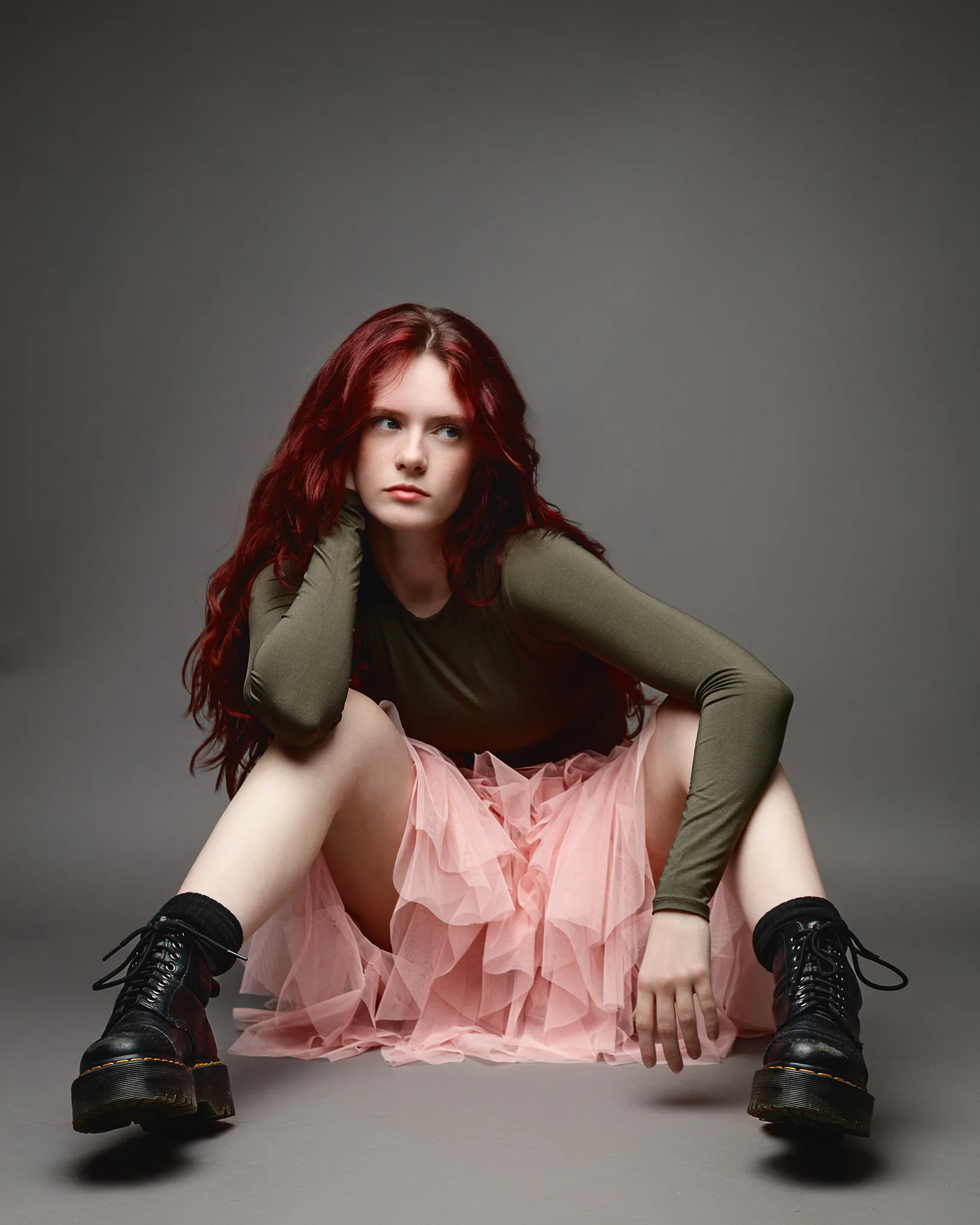 Red-haired woman in pink tulle skirt sitting
