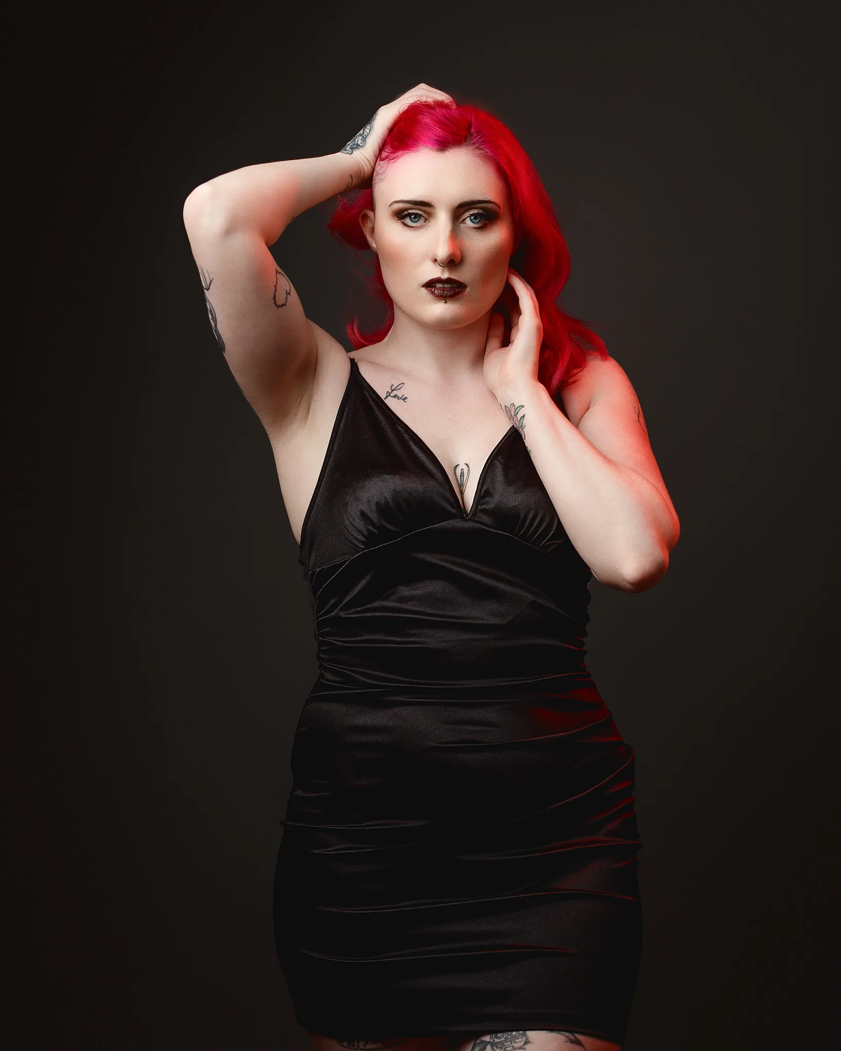 Woman with vibrant red hair wearing black dress