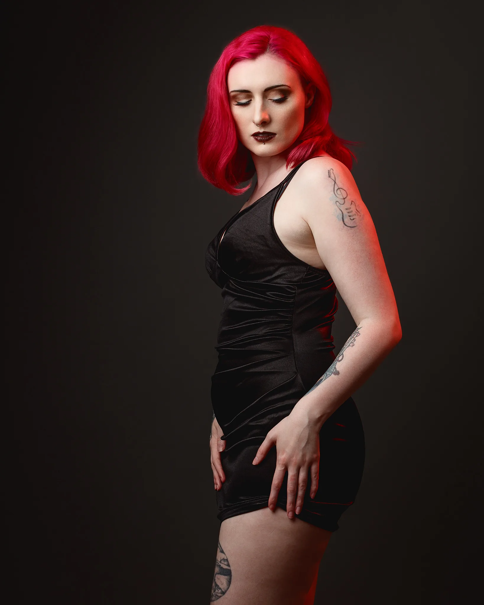 Woman with vibrant red hair wearing black dress