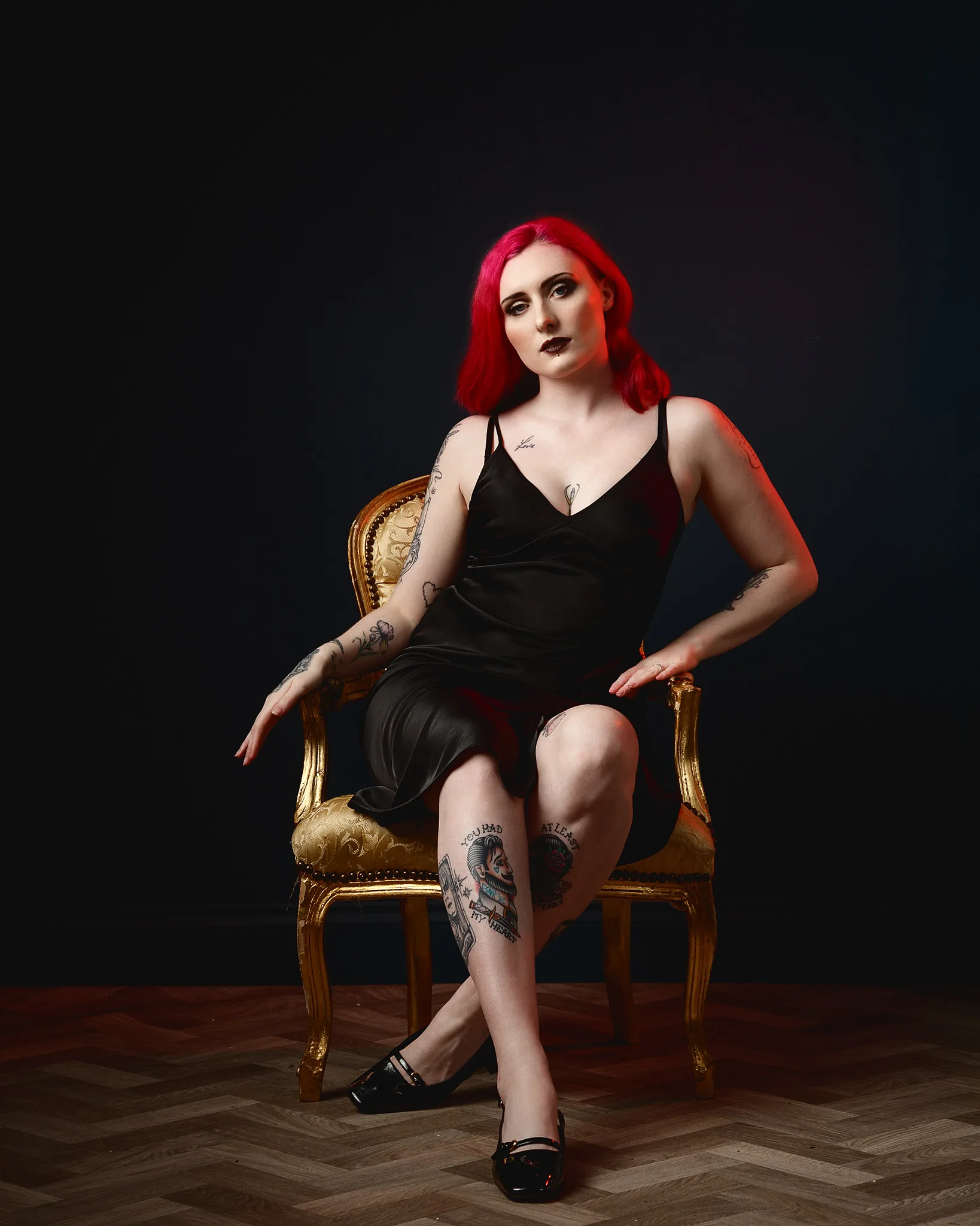 Woman with red hair sitting on ornate gold chair