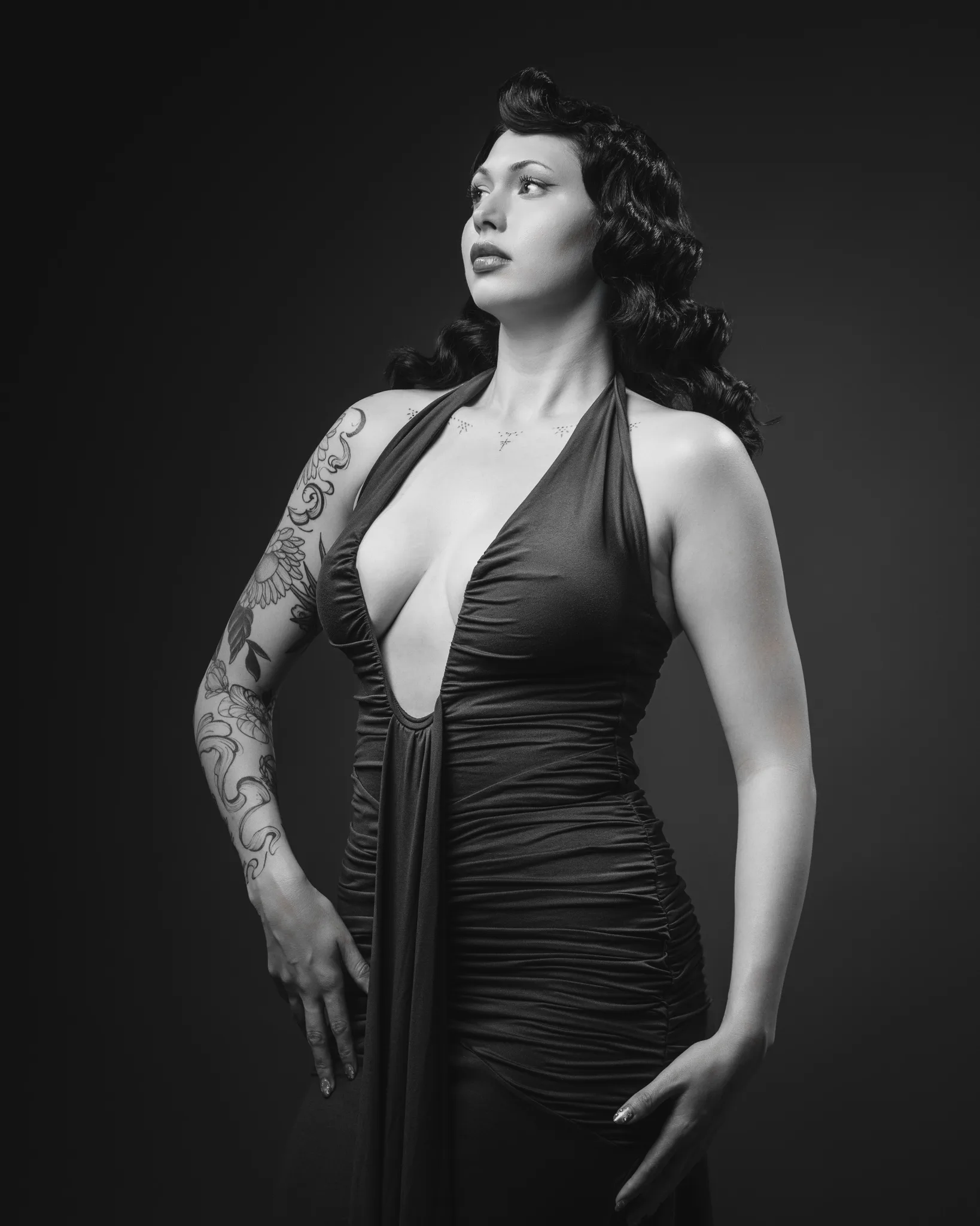 Black and white portrait of woman with vintage waves and tattoo