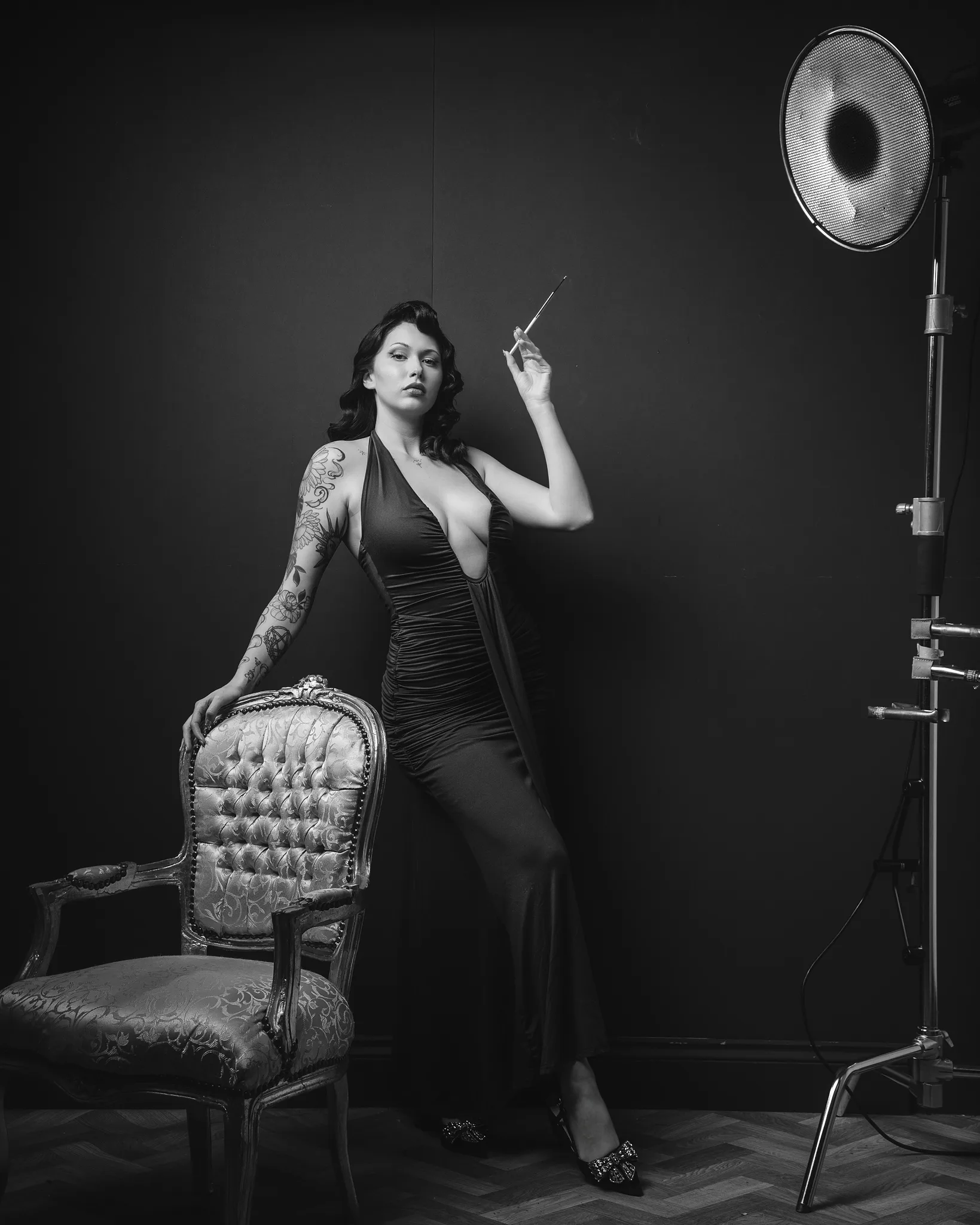Black and white portrait of tattooed woman with vintage studio lighting