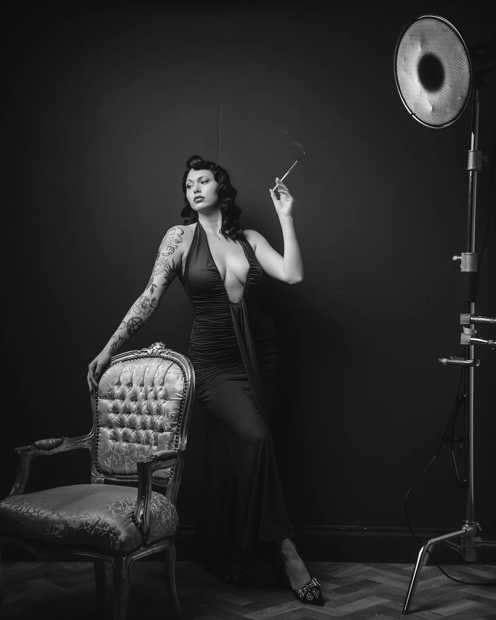 Vintage black and white portrait of tattooed woman in studio