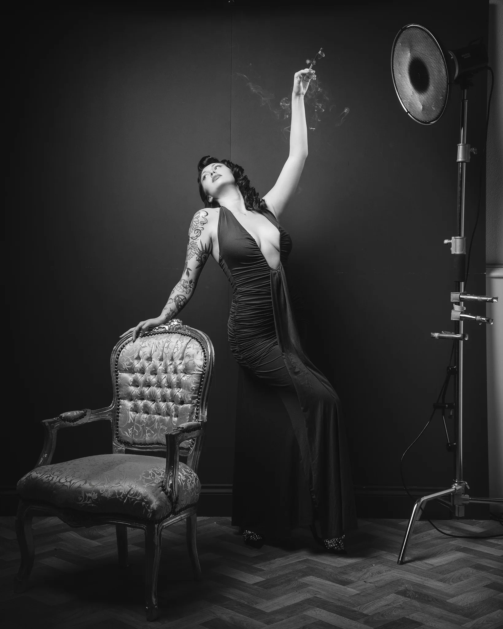 Tattooed woman singing into microphone in studio setting