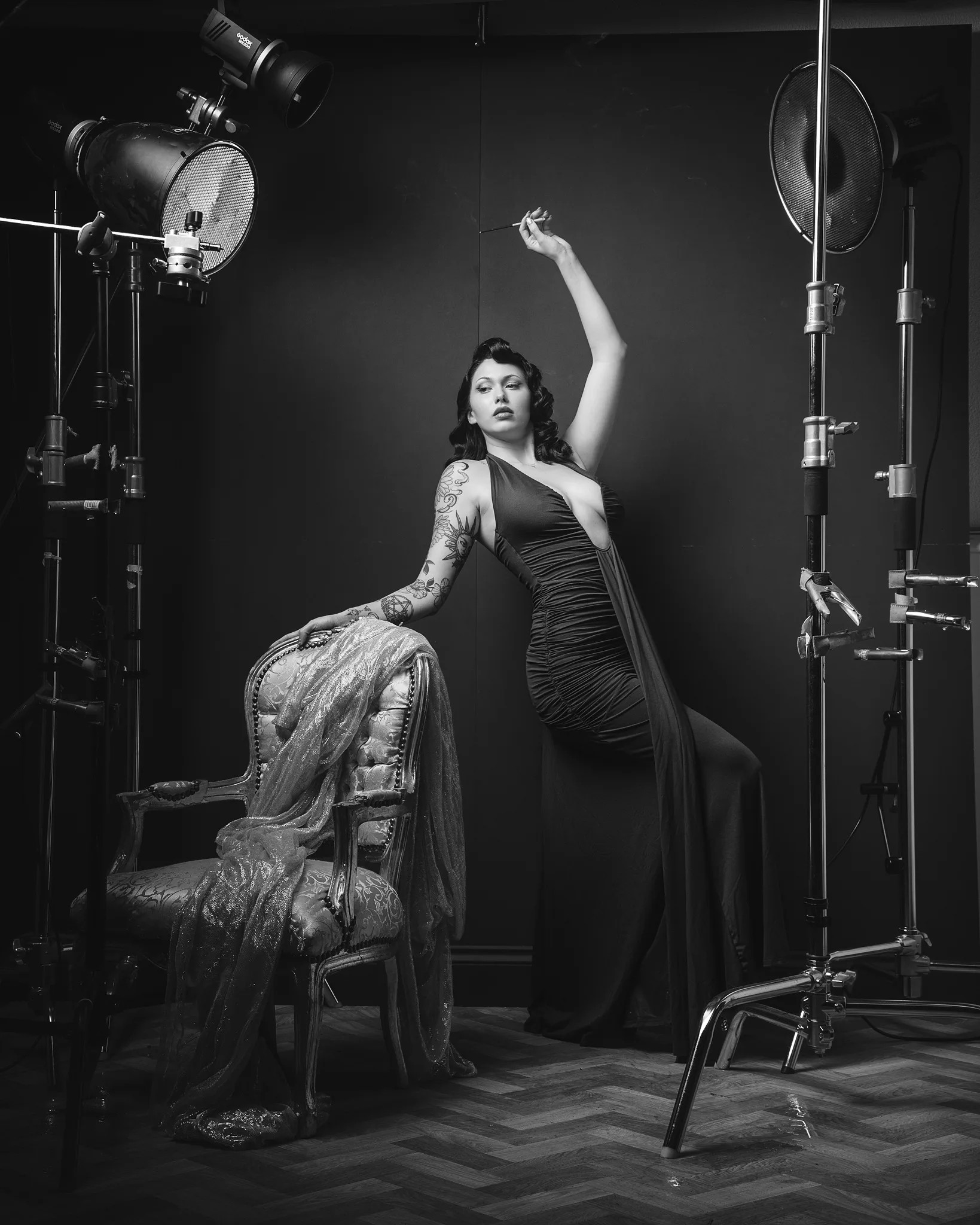 Woman in studio with professional lighting equipment and ornate chair