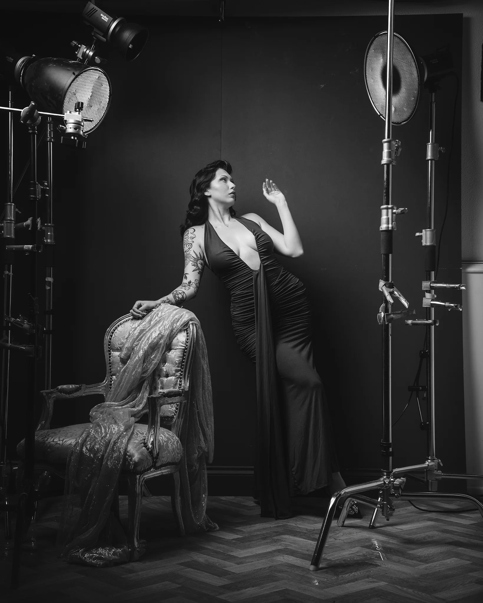 Woman in vintage dress posing under professional studio lighting