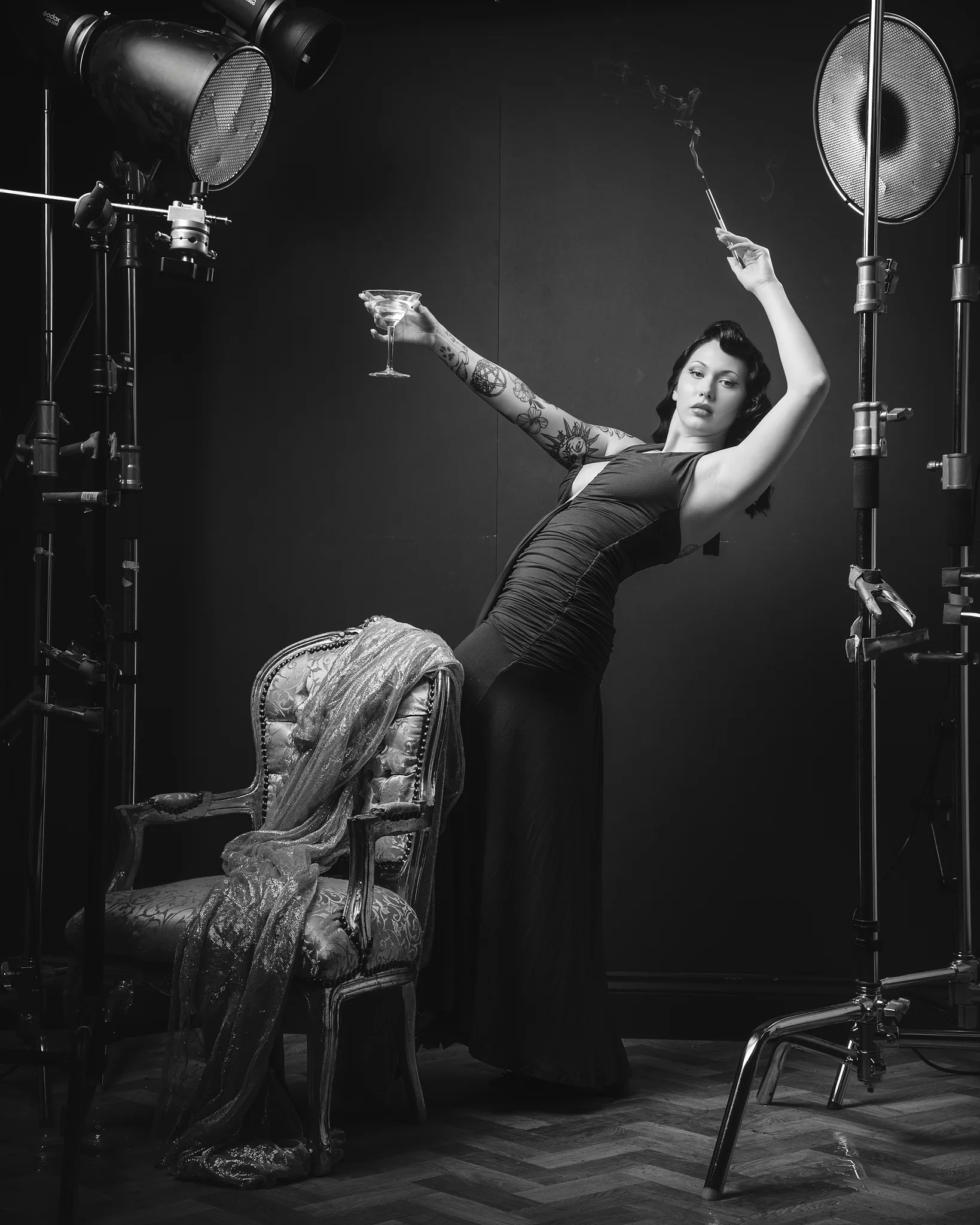 Woman in studio surrounded by professional film lighting equipment
