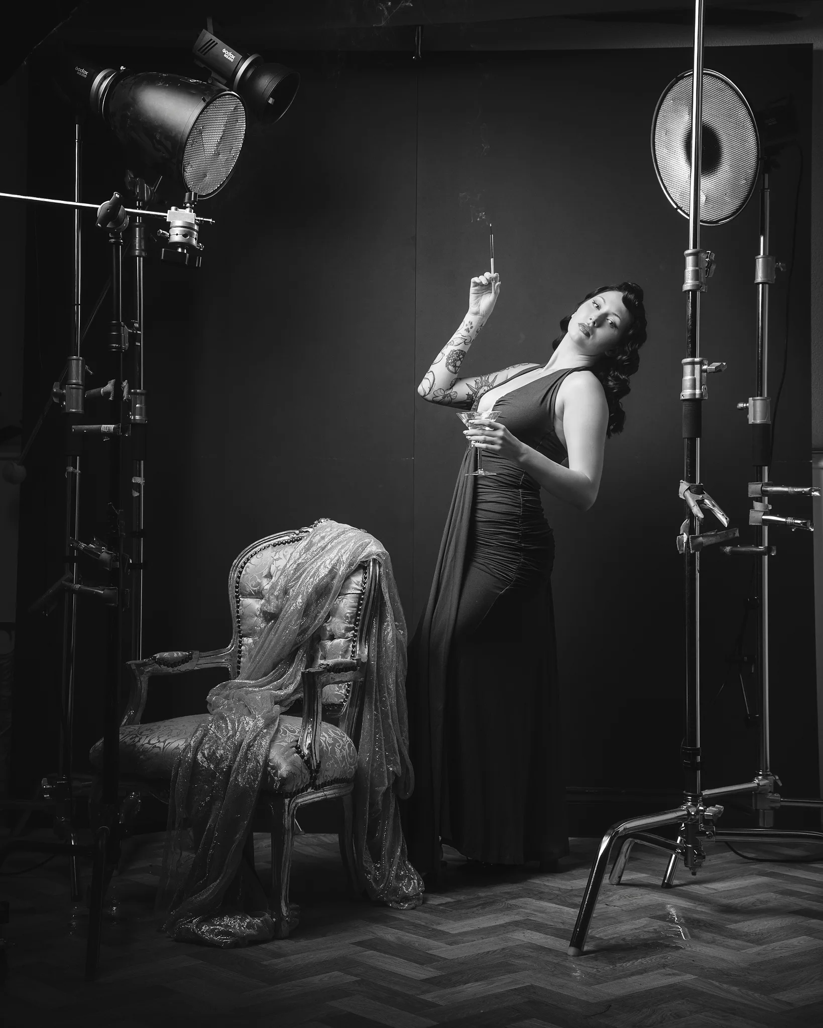 Woman posing in vintage studio with professional film lighting equipment