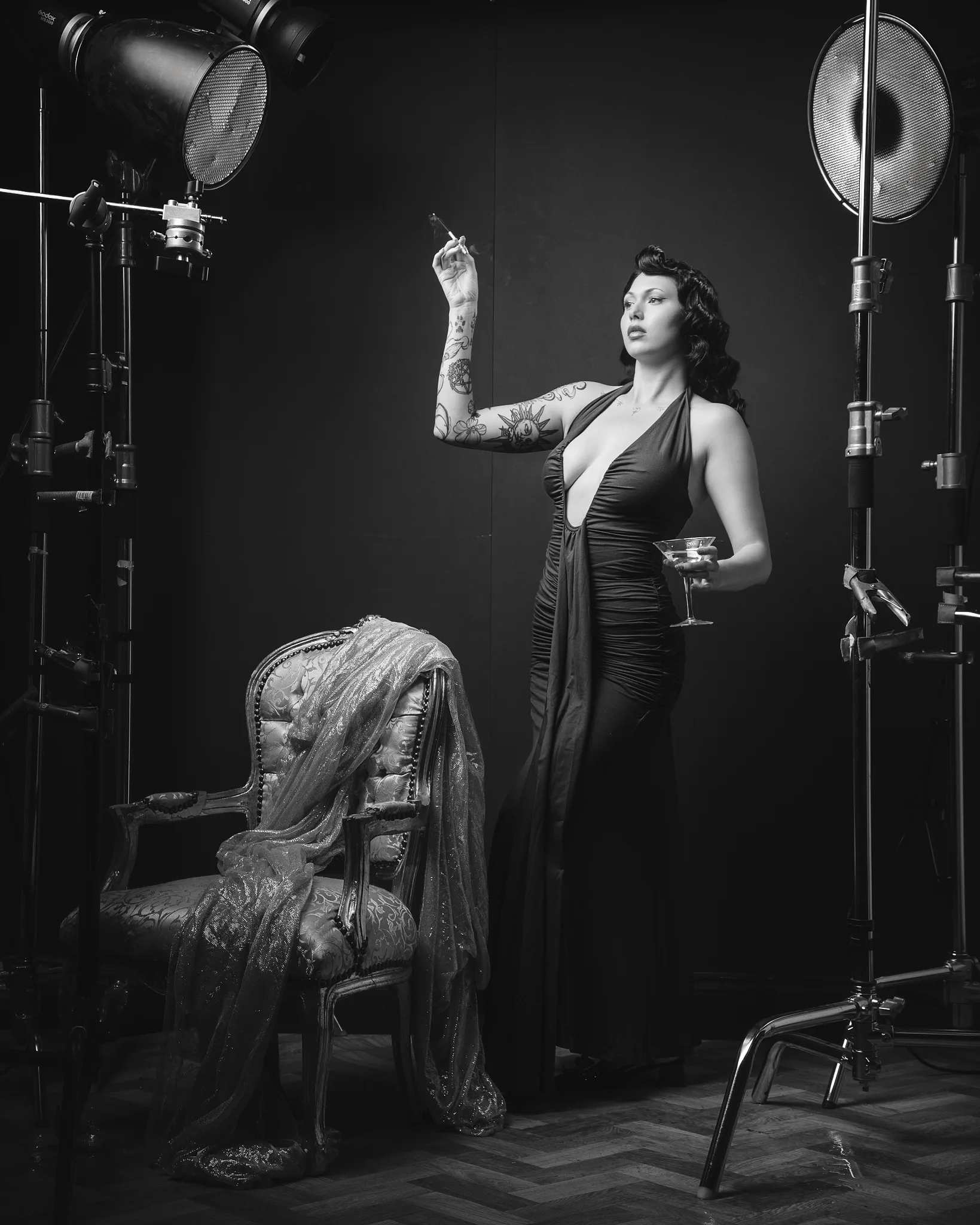 Tattooed woman in vintage studio setting with film lights