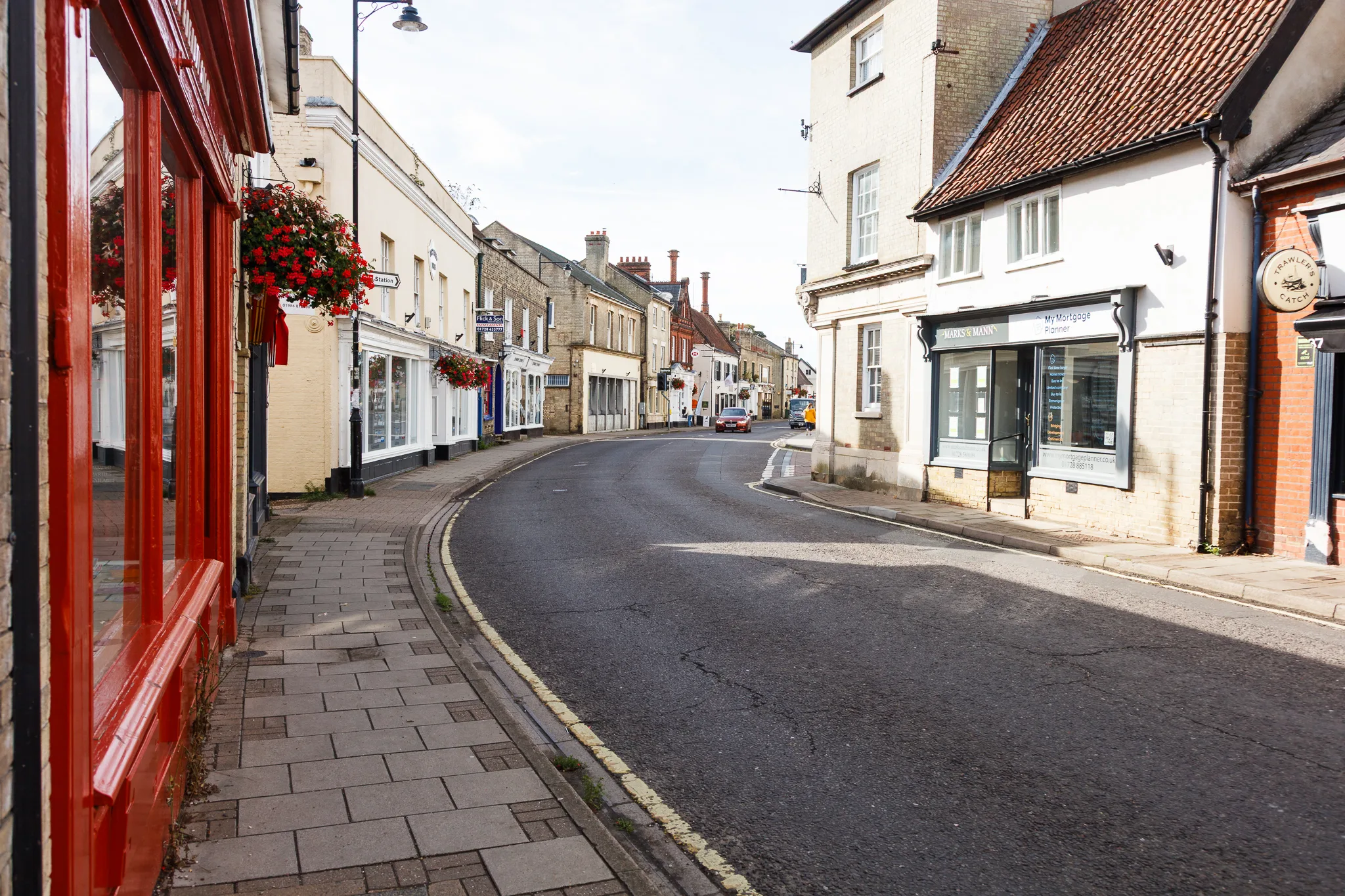 Charming English village high street with red-fronted shop