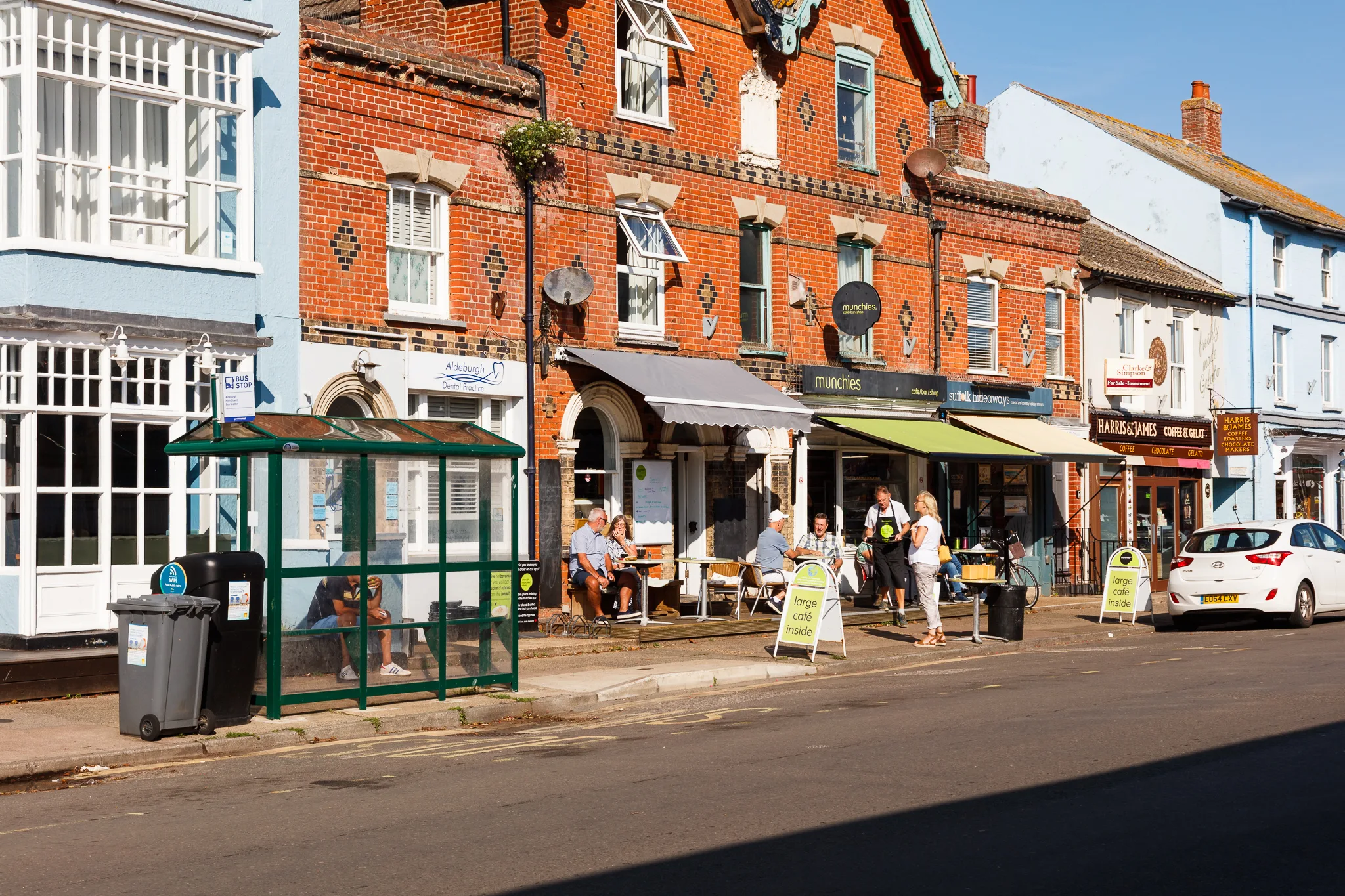 Charming high street with red brick buildings and outdoor cafés