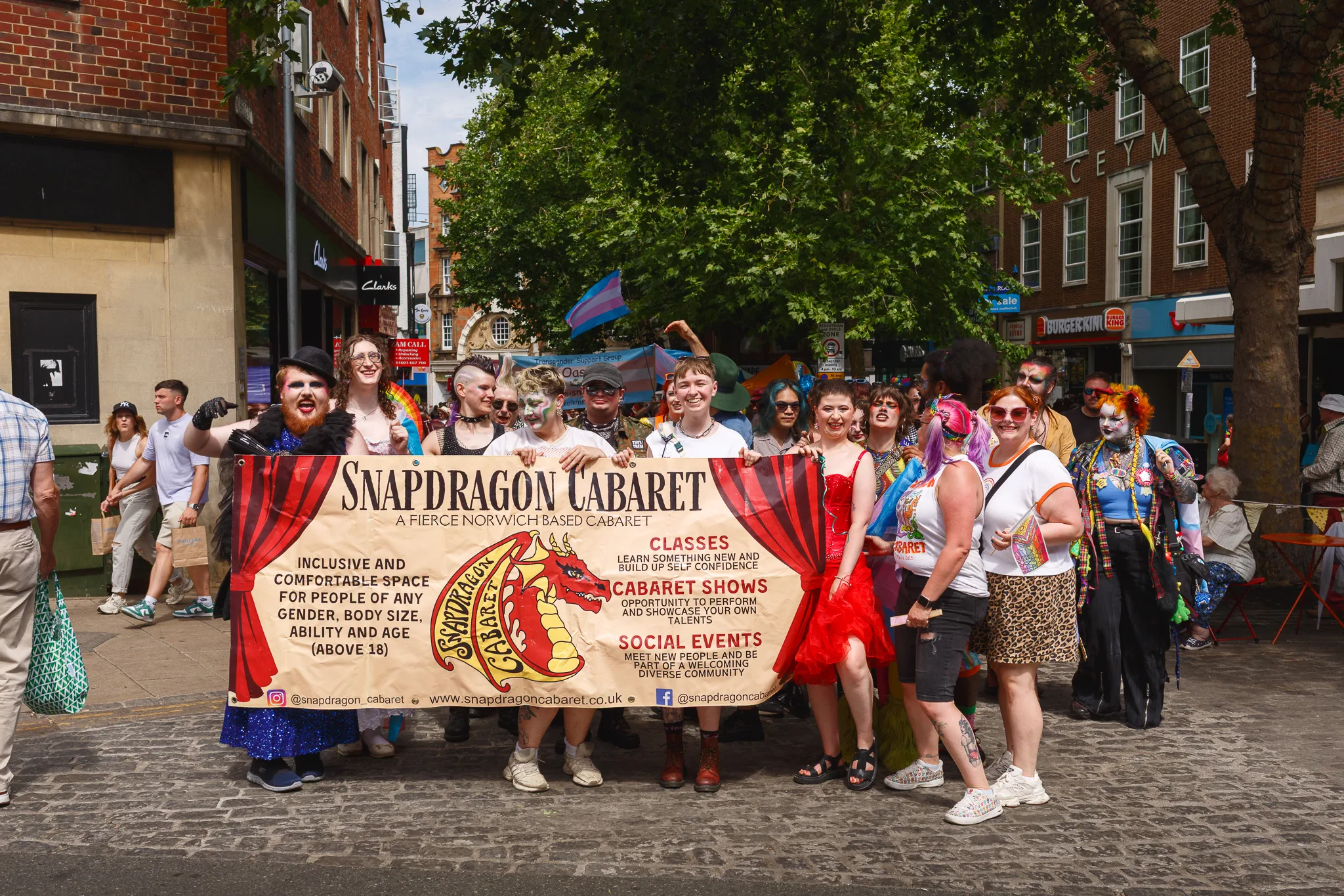 Snapdragon Cabaret group holding banner at Norwich Pride parade