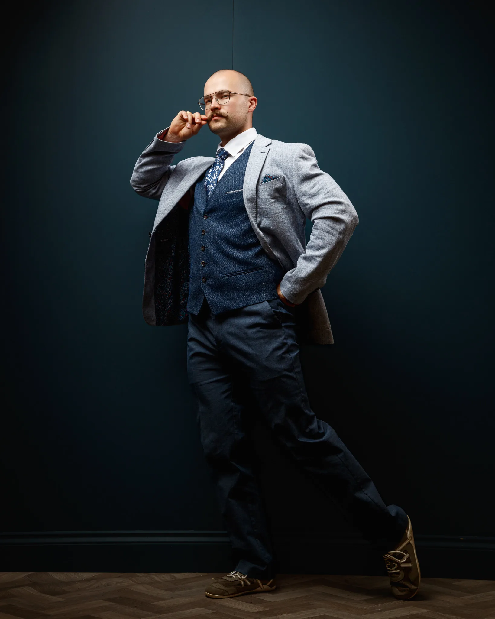 Professional man in business attire against dark blue background