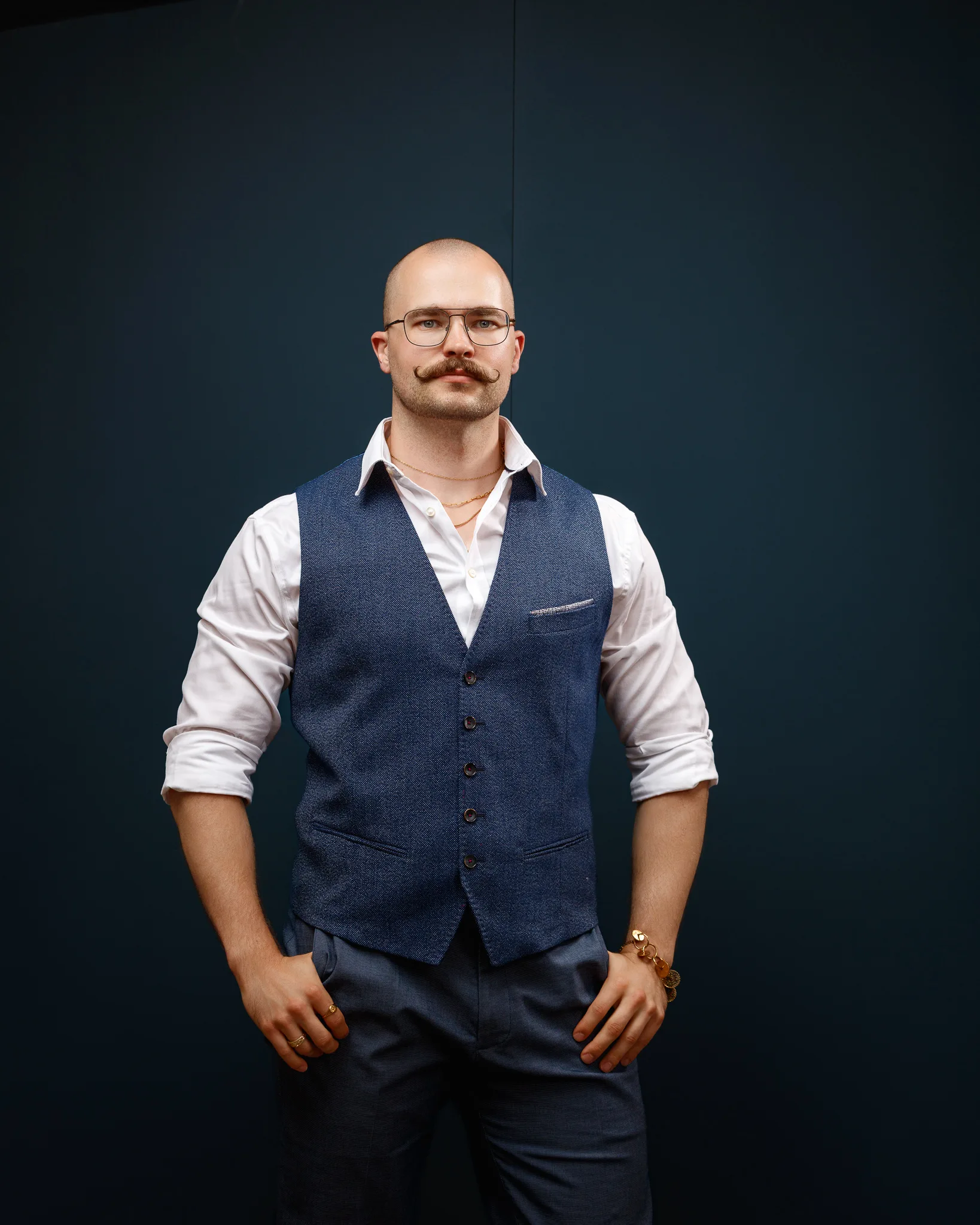 Man wearing glasses, vest and white shirt portrait